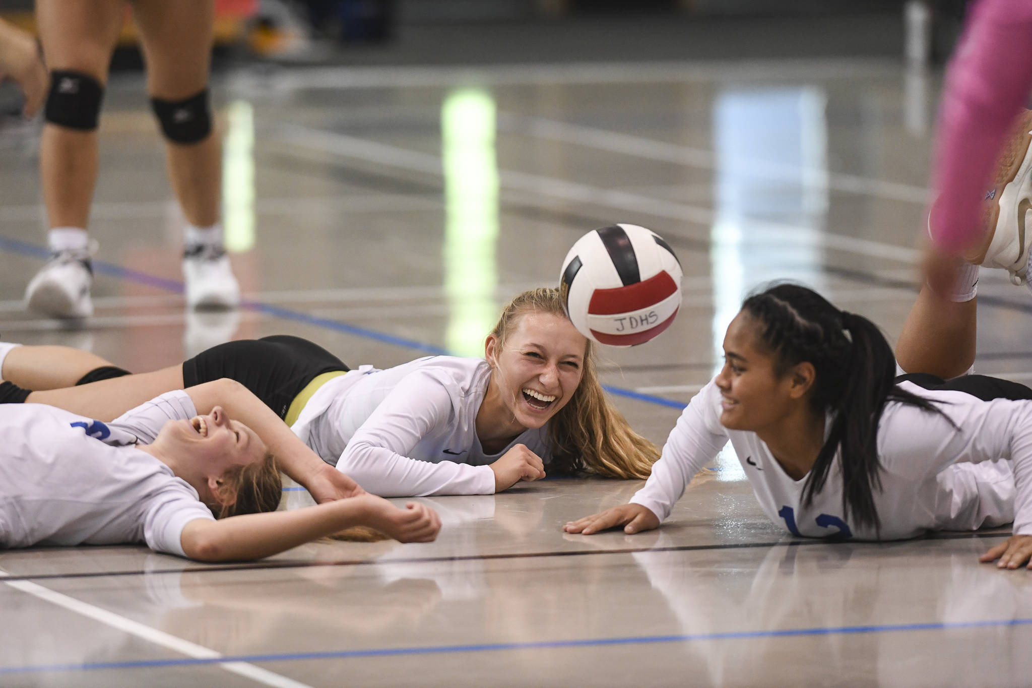 Thunder Mountain’s Sophie Harvey, left, Lily Smith, center, and Mariah Tunavasa-Tuvaifale laugh over a failed attempt against Mt. Edgecumbe at the Volleyball Jamboree at Juneau-Douglas High School: Yadaa.at Kalé on Friday, Aug. 30, 2019. (Michael Penn | Juneau Empire)