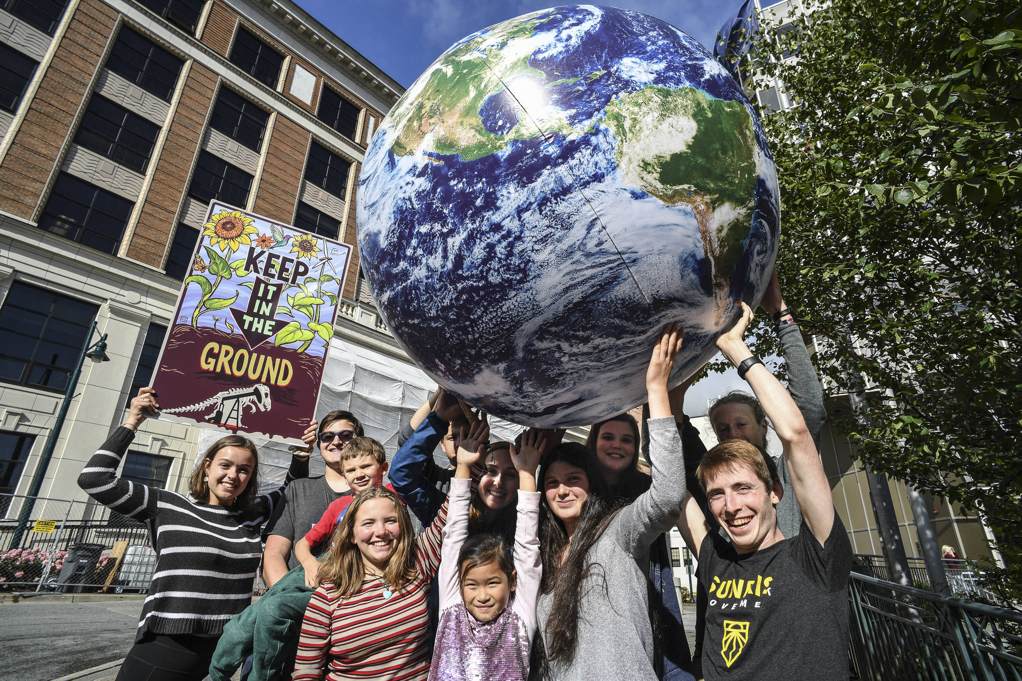 Students associated with 350 Juneau, a local chapter of an international grassroots climate movement, meet Tuesday, Sept. 3, 2019, in front of the Alaska State Capitol. They promoted a “Stand Strong for Climate Rally” to be held Tuesday, Sept. 10 at noon in front of the Capitol. (Michael Penn | Juneau Empire)