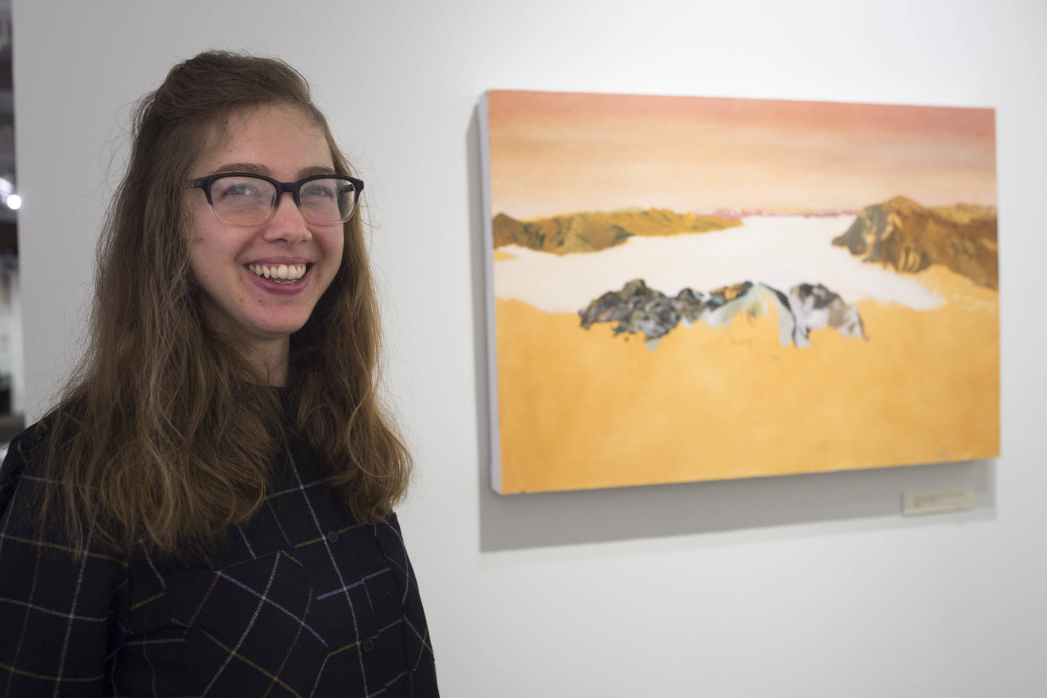 Crystal Cudworth stands with her oil painting “Wasterock is the Reason for Juneau” on display at the Juneau-Douglas City Museum in February 2019. She will be part of this week’s First Friday festivities. (Michael Penn | Juneau Empire File)