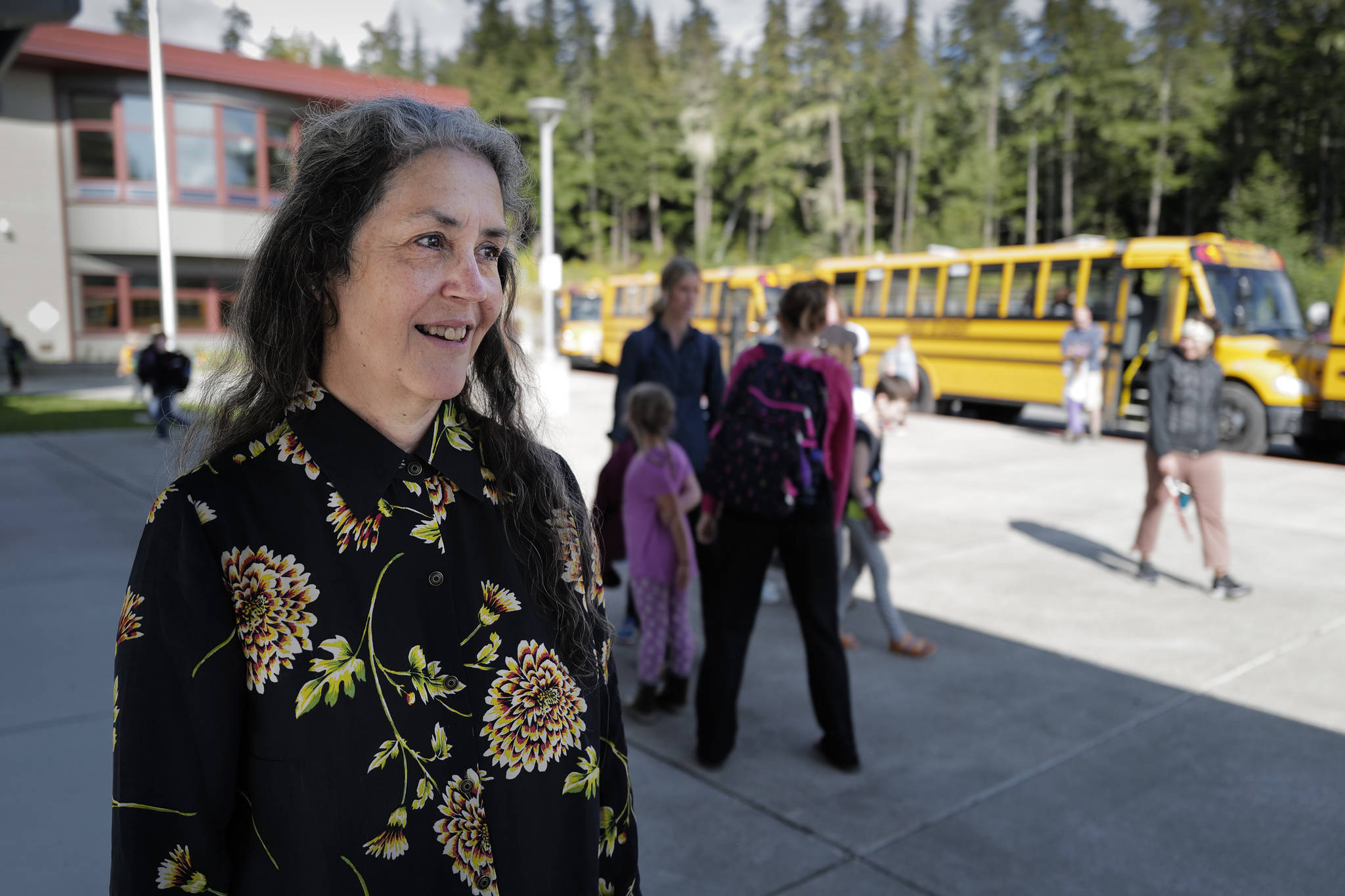 Pam Garcia, a long-time educator at Auke Bay Elementary School, watches as students catch their buses after school on Tuesday, Sept. 3, 2019. Garcia was named as one of three finalist for Alaska Teacher of the Year. (Michael Penn | Juneau Empire)
