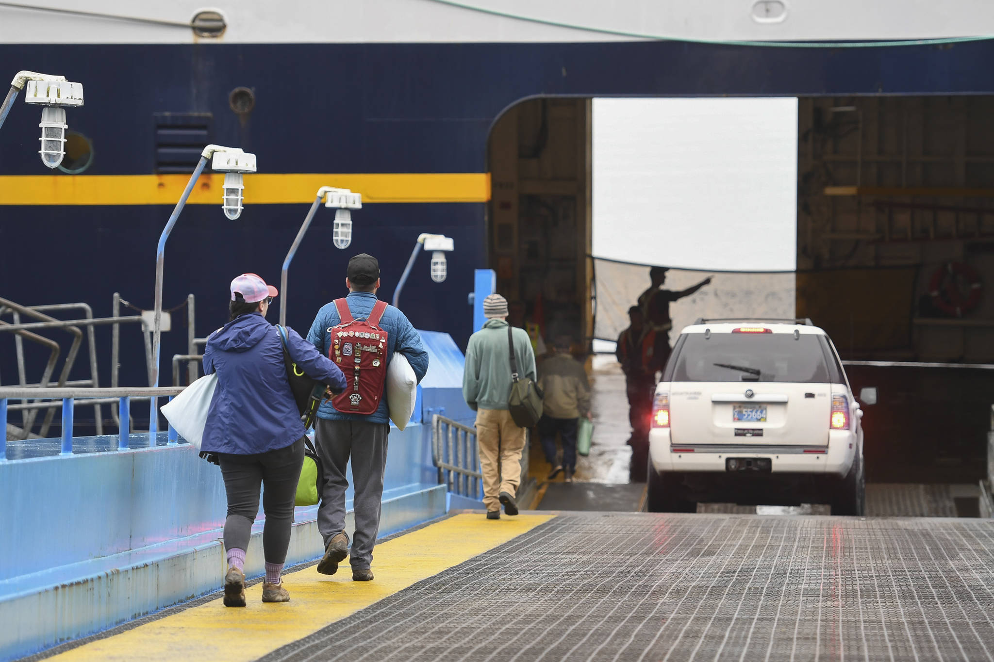 Walk-on passengers and vehicles load onto the LeConte ferry for a trip to Hoonah and Gustavus at the Alaska Marine Highway System’s Auke Bay Terminal on Friday, July 19, 2019. (Michael Penn | Juneau Empire file)
