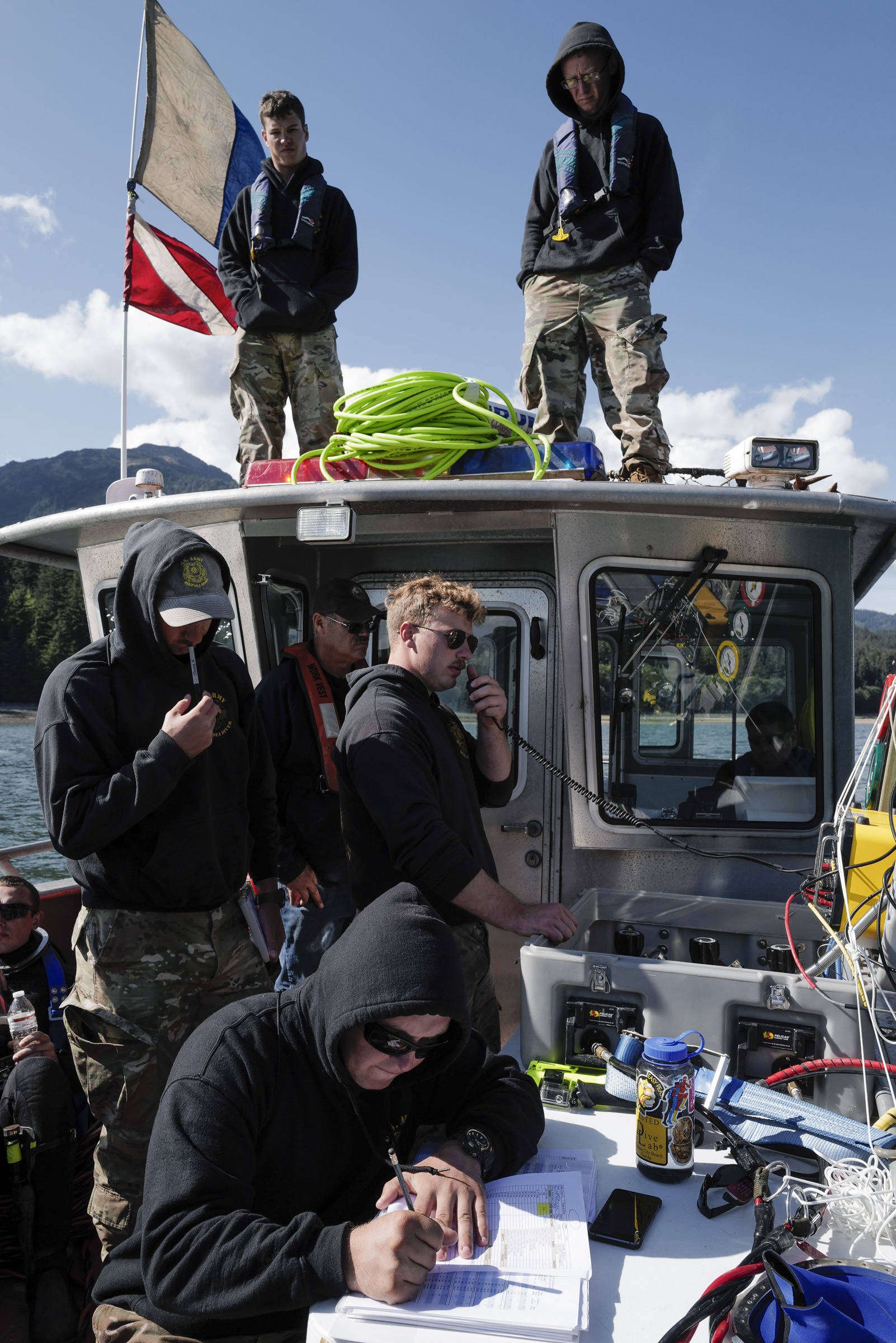 Members of the Army’s 74th Engineer Dive Detachment work off a Juneau Harbormaster boat to retrieve lost crab pots in Gastineau Channel for the Douglas Indian Association/NOAA Marine Debris Project on Thursday, Sept. 5, 2019. The project aims to identify and remove derelict crab pots and their continued negative impact on wildlife and the environment. (Michael Penn | Juneau Empire)