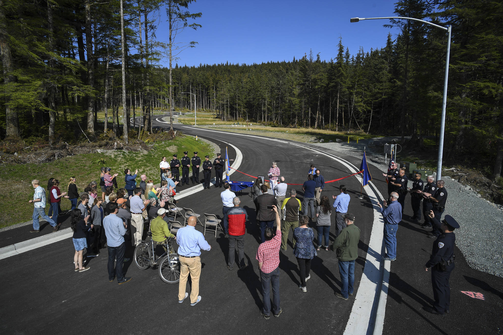 Mayor Beth Weldon speaks at a ribbon-cutting ceremony on Karl Reishus Boulevard commemorating the near completion of the Pederson Hill Subdivision on Friday, Sept. 6, 2019. Reishus was a Juneau Police Department officer who died in 1992 when he fell from a 40-foot tower during a training exercise. (Michael Penn | Juneau Empire)
