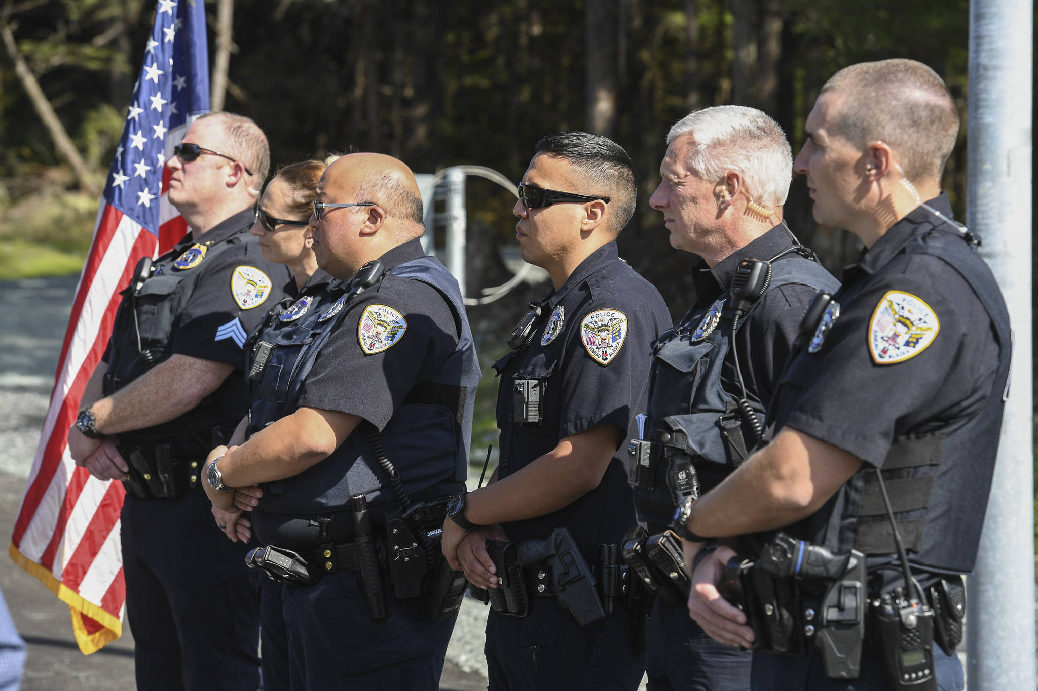 Juneau Police Department officers attend a ribbon-cutting ceremony on Karl Reishus Boulevard to commemorate the near completion of the Pederson Hill Subdivision on Friday, Sept. 6, 2019. Reishus was a Juneau Police Department officer who died in 1992 when he fell from a 40-foot tower during a training exercise. (Michael Penn | Juneau Empire)
