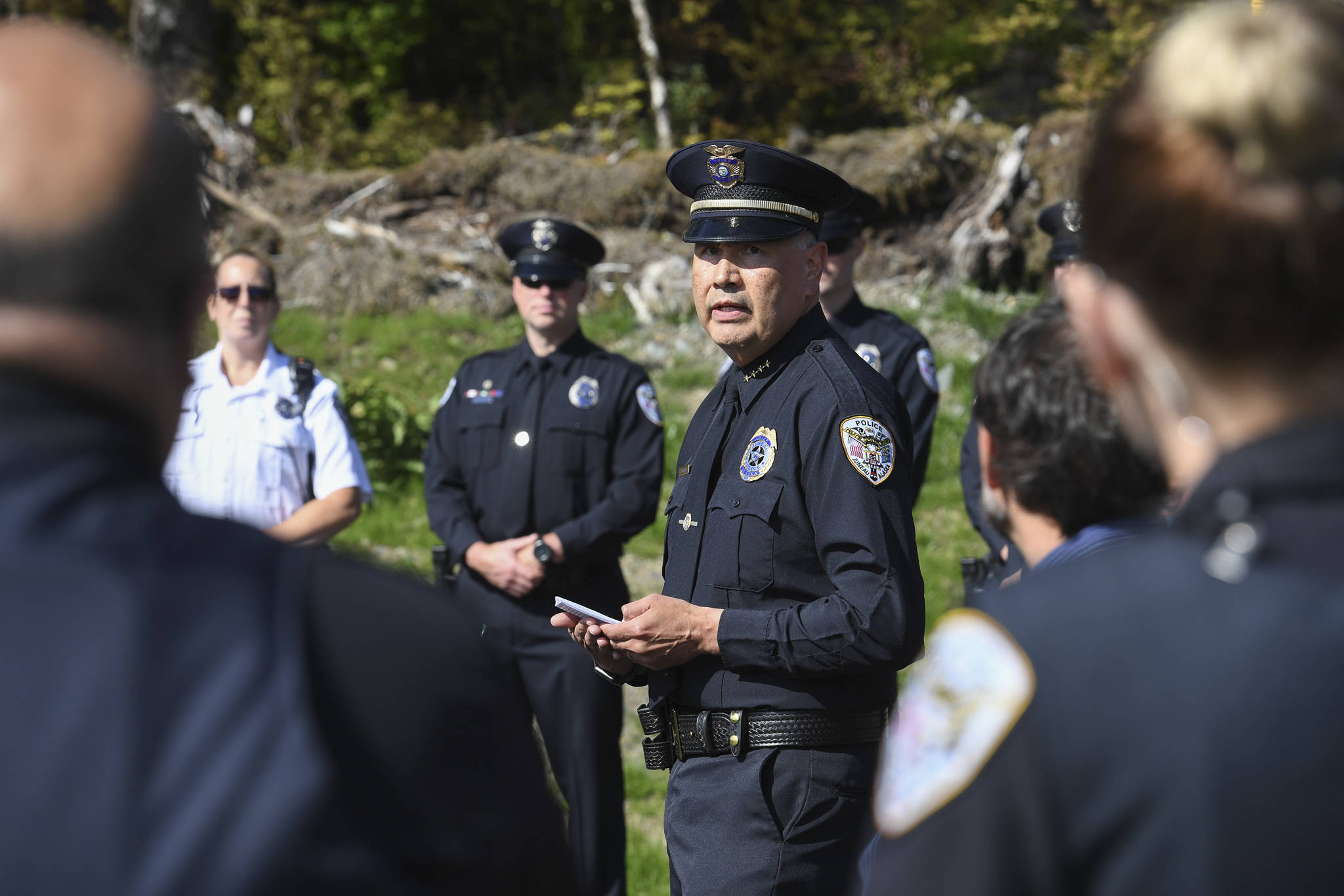 Juneau Police Department Chief Ed Mercer and his officers attend a ribbon-cutting ceremony on Karl Reishus Boulevard to commemorate the near completion of the Pederson Hill Subdivision on Friday, Sept. 6, 2019. Reishus was a Juneau Police Department officer who died in 1992 when he fell from a 40-foot tower during a training exercise. (Michael Penn | Juneau Empire)