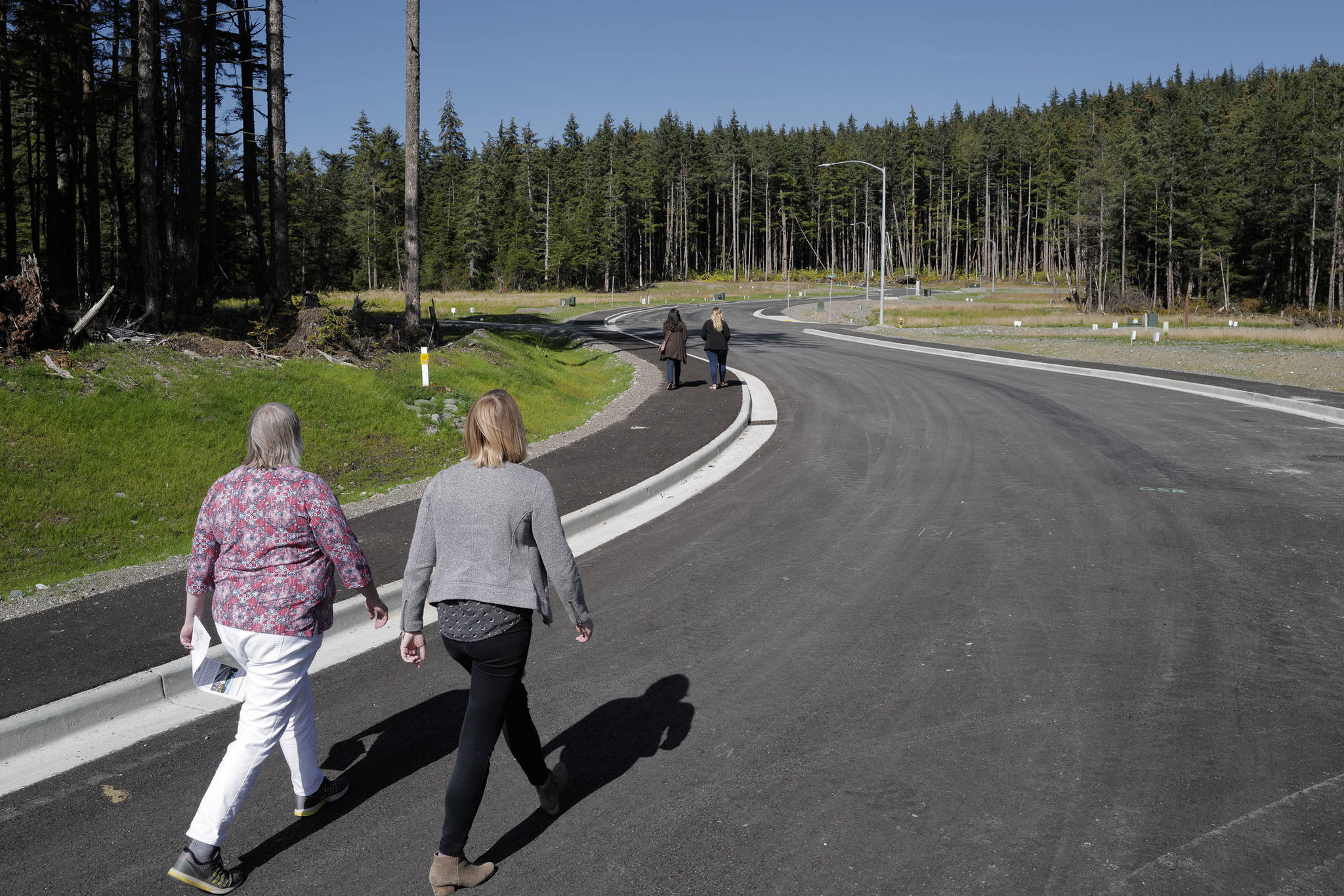 Mayor Beth Weldon and Assembly Member Carole Triem take a stroll on Karl Reishus Boulevard after a ribbon-cutting ceremony to commemorate the near completion of the Pederson Hill Subdivision on Friday, Sept. 6, 2019. Reishus was a Juneau Police Department officer who died in 1992 when he fell from a 40-foot tower during a training exercise. (Michael Penn | Juneau Empire)