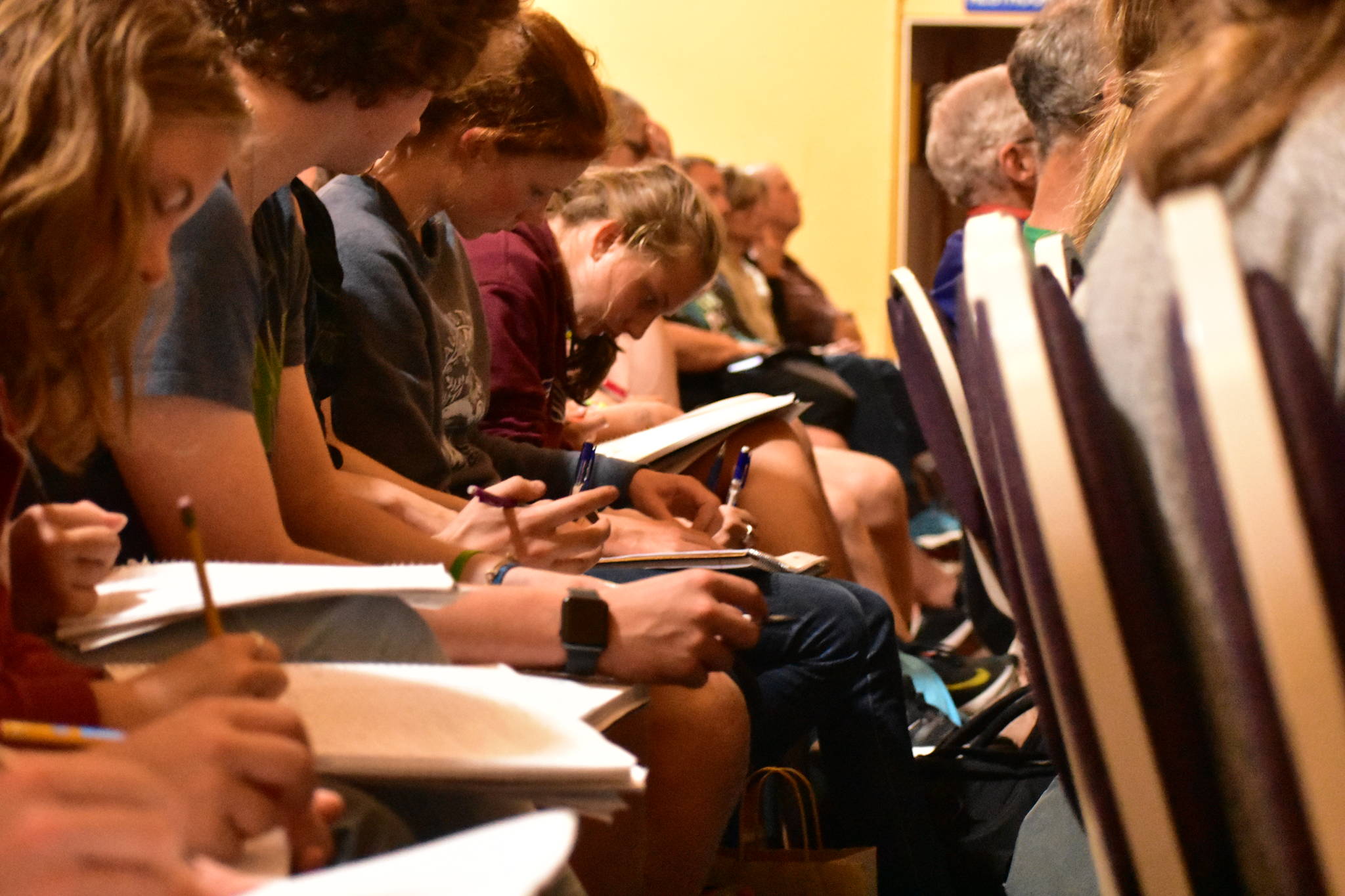 Students take notes during Dan Grossman’s lecture at the Juneau Arts and Humanities Council on Monday, Sept. 9, 2019. (Peter Segall | Juneau Empire)