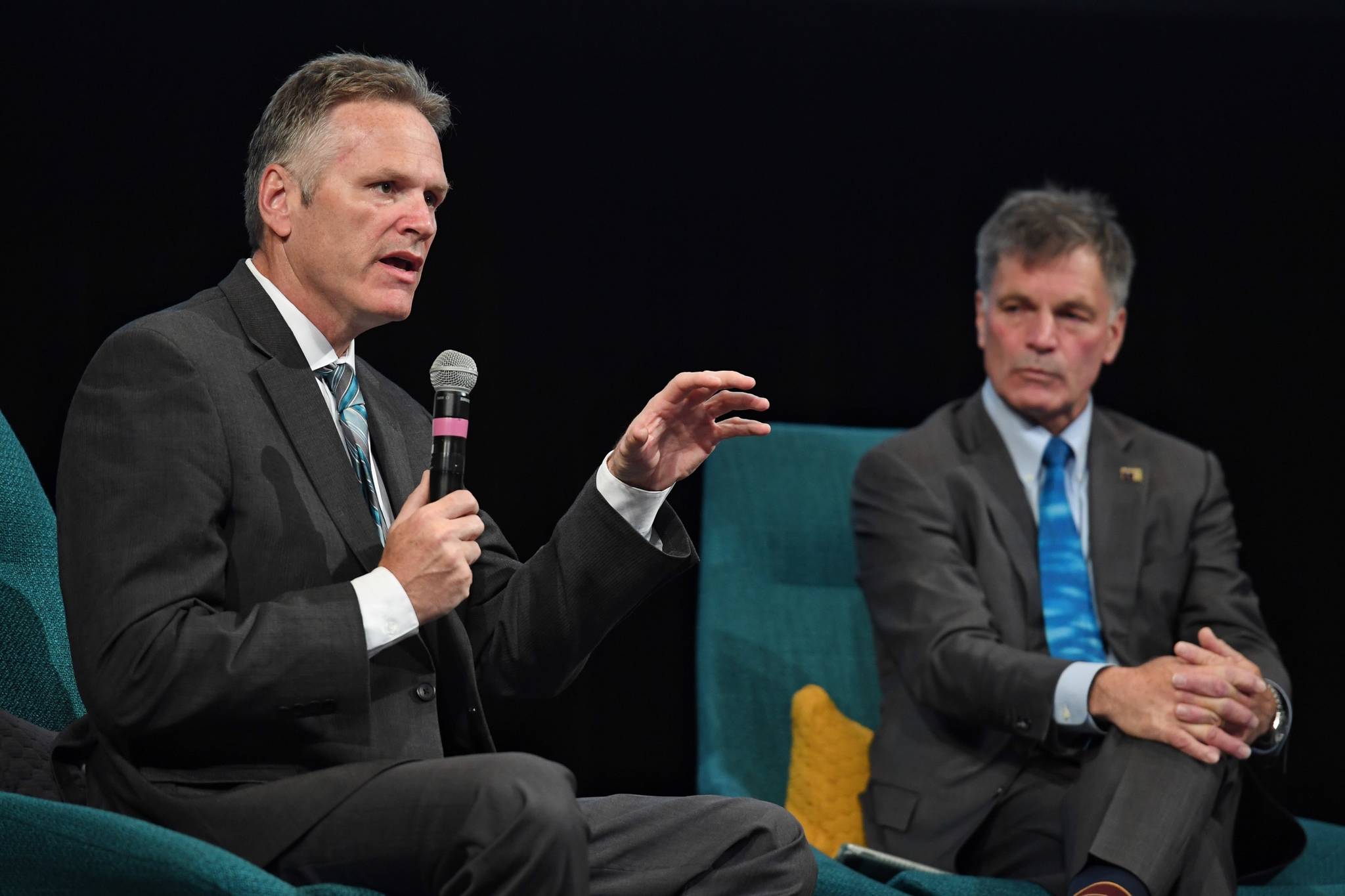 Alaska Gov. Mike Dunleavy, left, speaks with Wyoming Gov. Mark Gordon about the differences of their states during the annual meeting of the International Forum of Sovereign Wealth Funds at Centennial Hall on Thursday, Sept. 12, 2019. (Michael Penn| Juneau Empire)