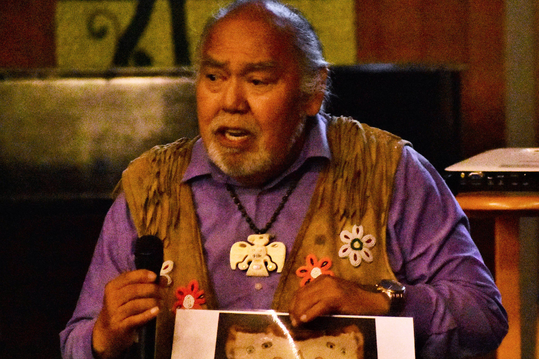 David Katzeek holds up a photo of a sun blanket at Northern Light United Church in Juneau during the “Climate Change Through the Eyes of Alaska Natives” forum on Sept. 12, 2019. (Peter Segall | Juneau Empire)