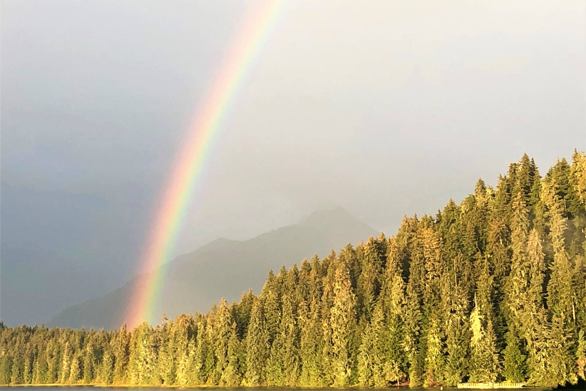 A rainbow over Auke Lake, just ahead of Katherine Hayhoe’s talk, “Christianity and Climate Change,” at Chapel by the Lake on Sept. 13, 2019. (Peter Segall | Juneau Empire )