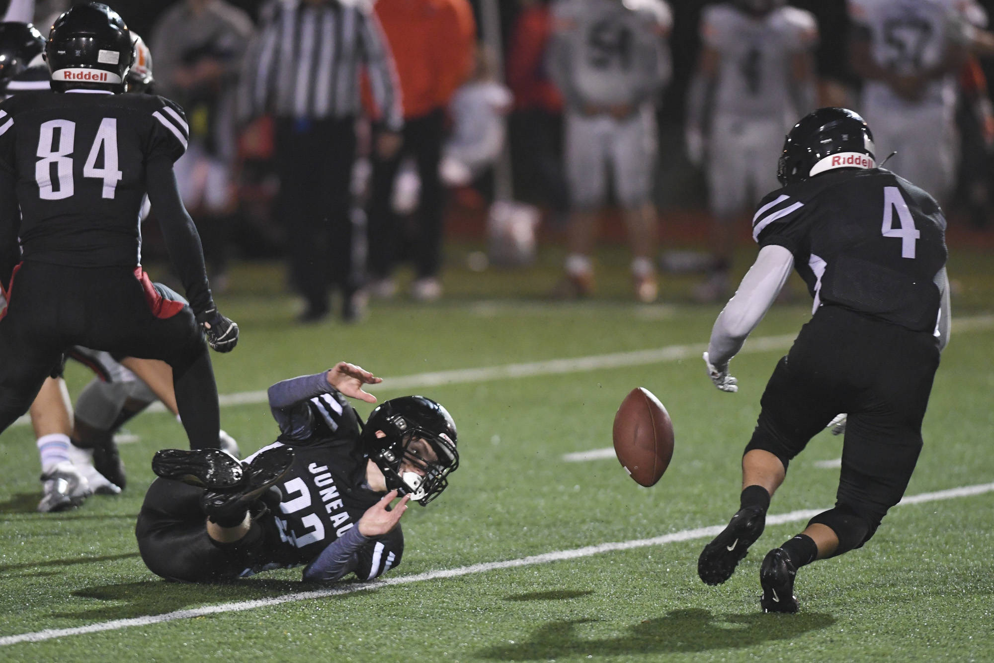 Juneau’s Ali Beya, right, recovers a fumble by teammate James Connally in the third quarter against West at Adair-Kennedy Memorial Field on Friday, Sept. 13, 2019. West won 43-14. (Michael Penn | Juneau Empire)