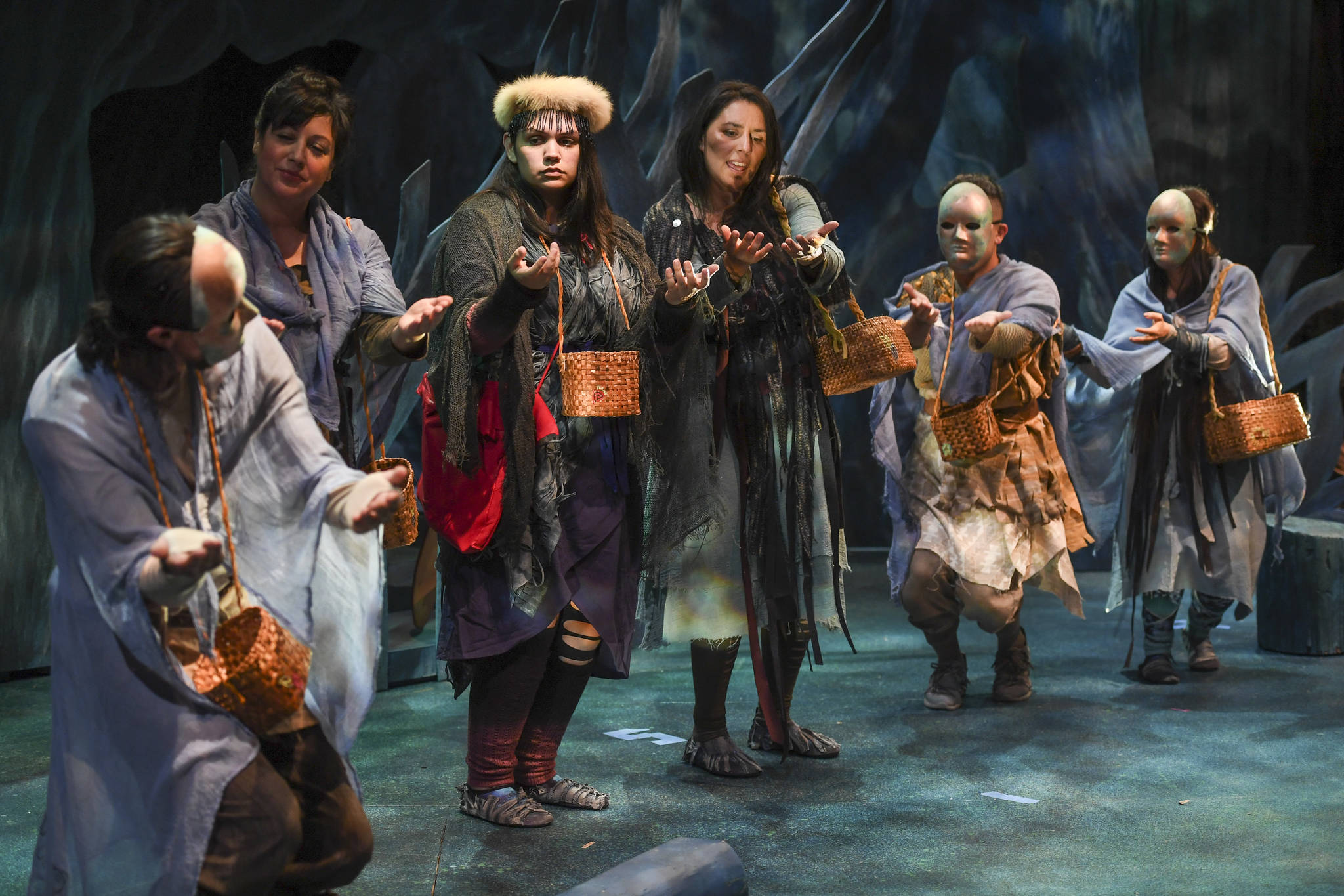 Erin Tripp, center, playing Aanteinatu, is welcomed into a new clan during the Perseverance Theatre’s production of “Devilfish” written by Vera Starbard on Tuesday, Sept. 17, 2019. (Michael Penn | Juneau Empire)