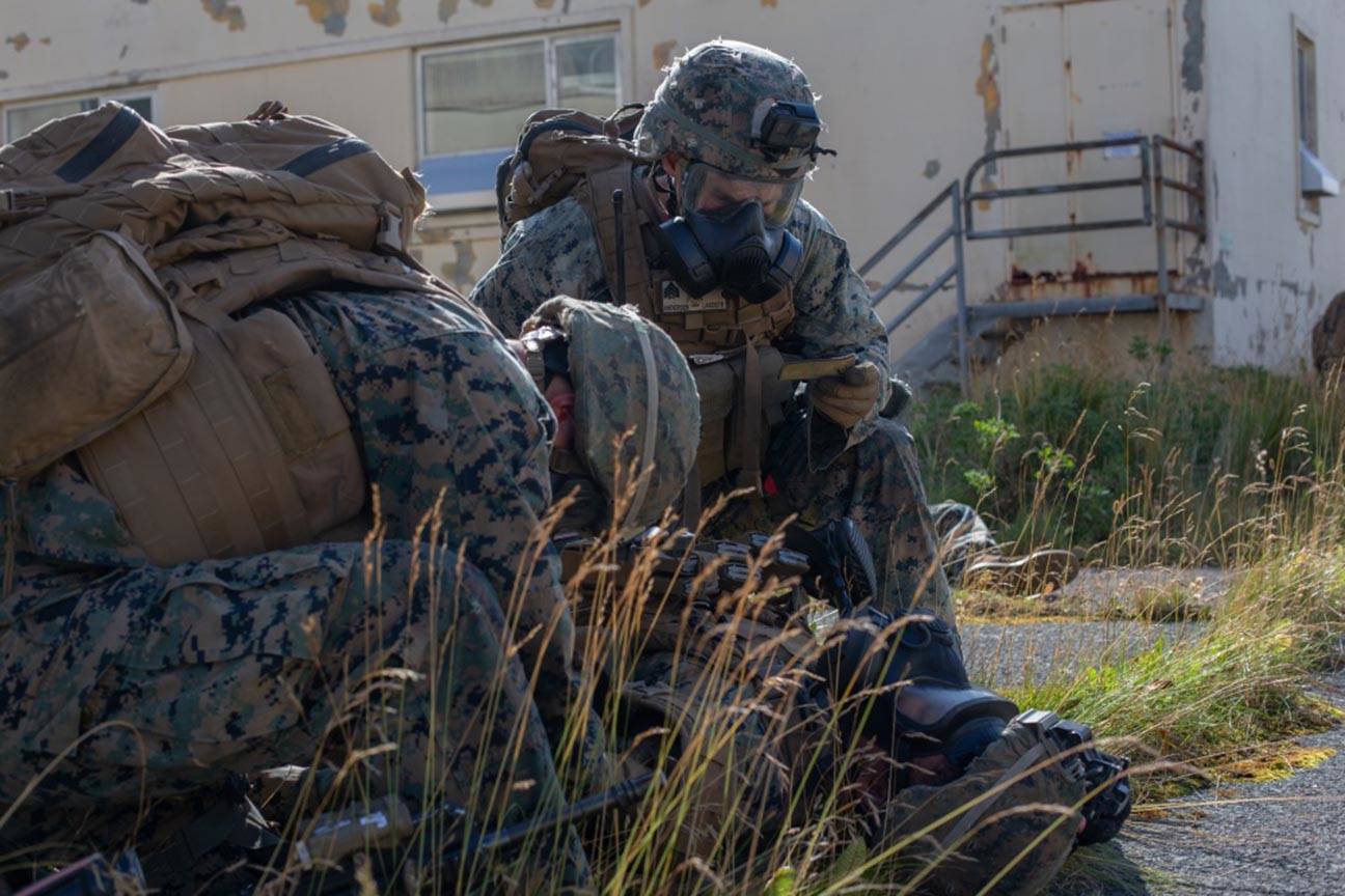 U.S. Marines with 3rd Battalion, 4th Marines aid a notionally injured Marine while simulating a raid during Arctic Expeditionary Capabilities Exercise (AECE) in Adak, Alaska, on Sept. 20, 2019. (U.S. Marine Corps photo by Lance Cpl. Tia D. Carr)