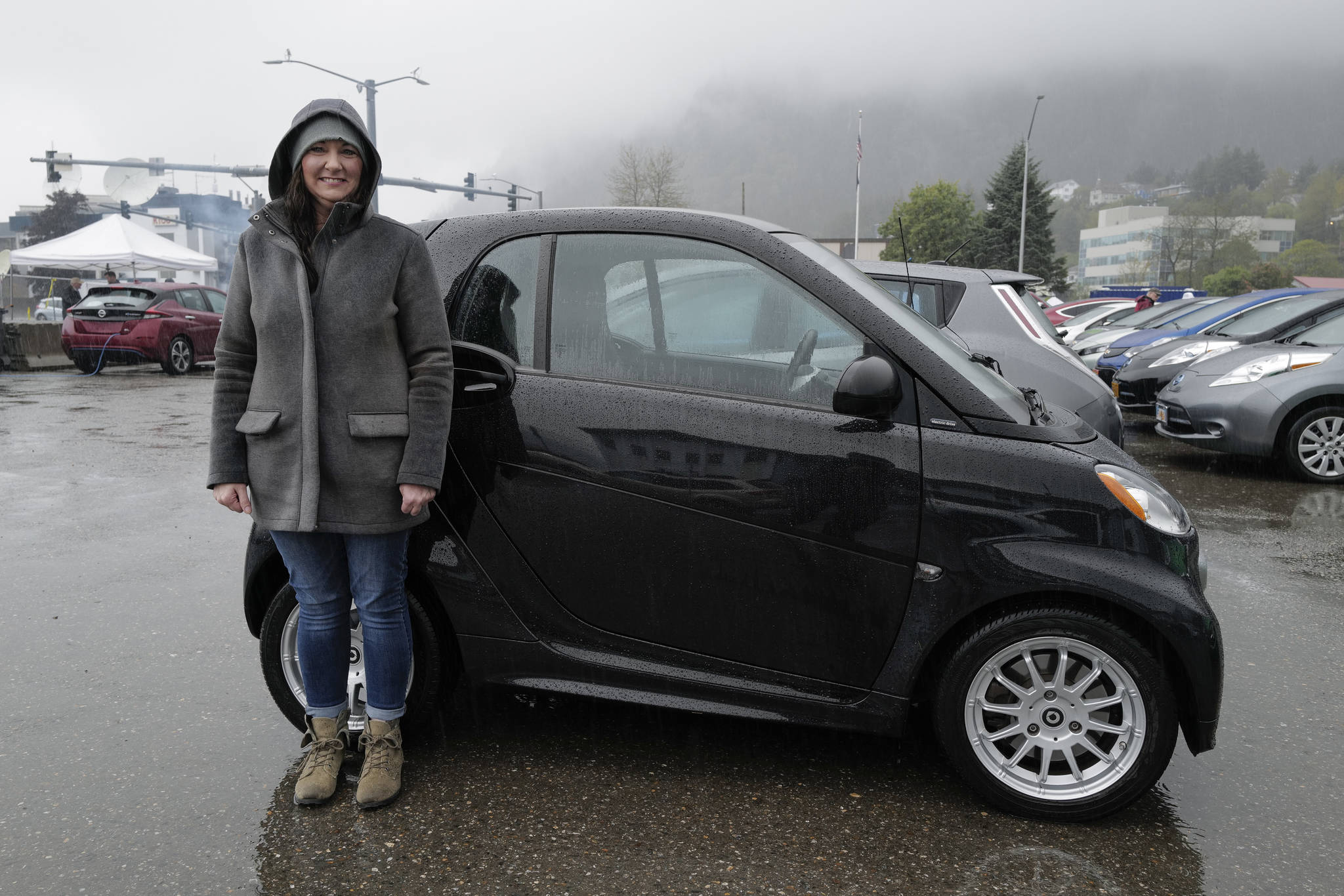 Nikki Hogan poses with her 2014 Electric Smart Car as Juneau residents meet for the Sixth Annual Electric Vehicle Juneau Roundup on Saturday, Sept. 21, 2019. (Michael Penn | Juneau Empire)