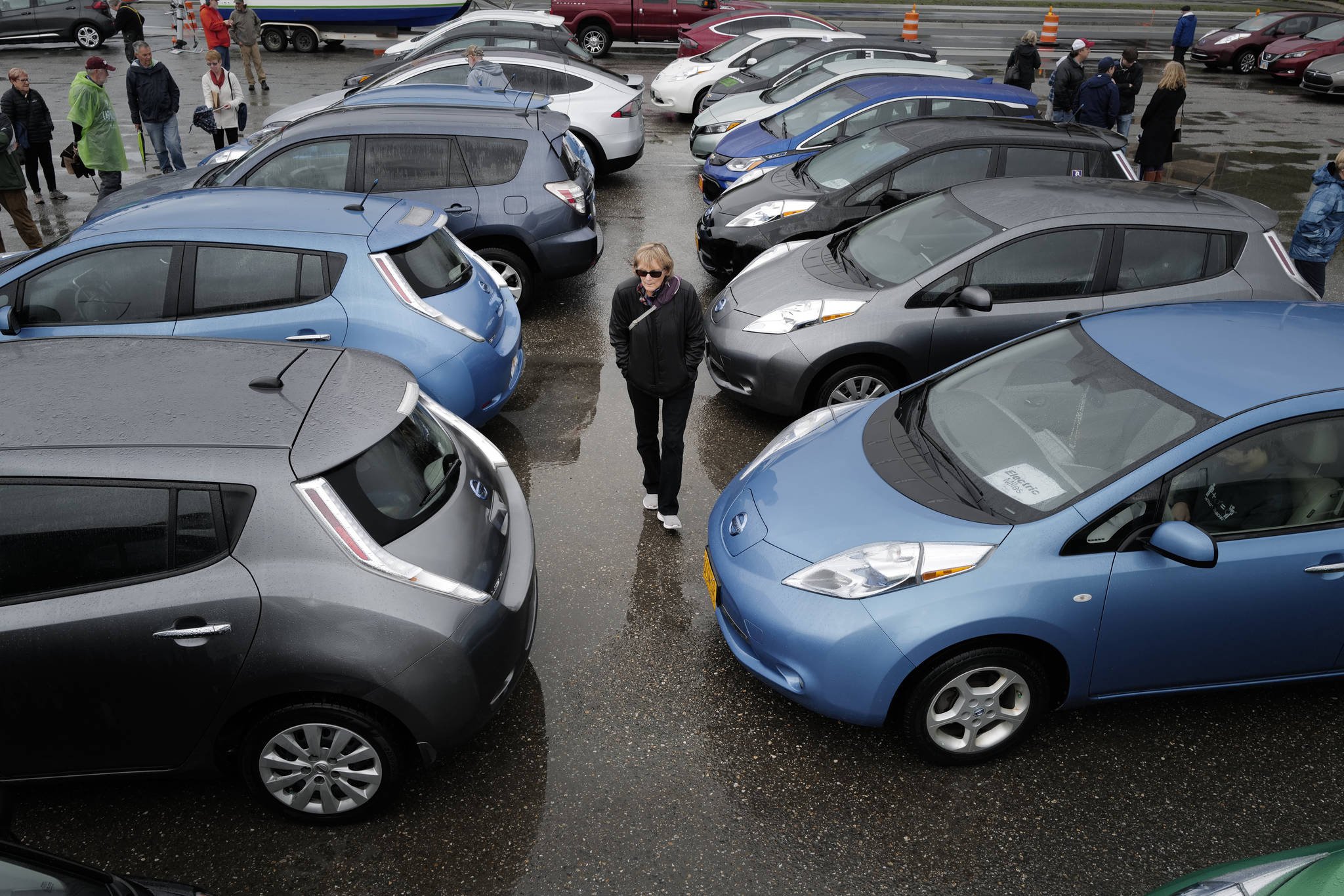 Teri Sears walks between rows of electric vehicles during the Sixth Annual Electric Vehicle Juneau Roundup on Saturday, Sept. 21, 2019. (Michael Penn | Juneau Empire)