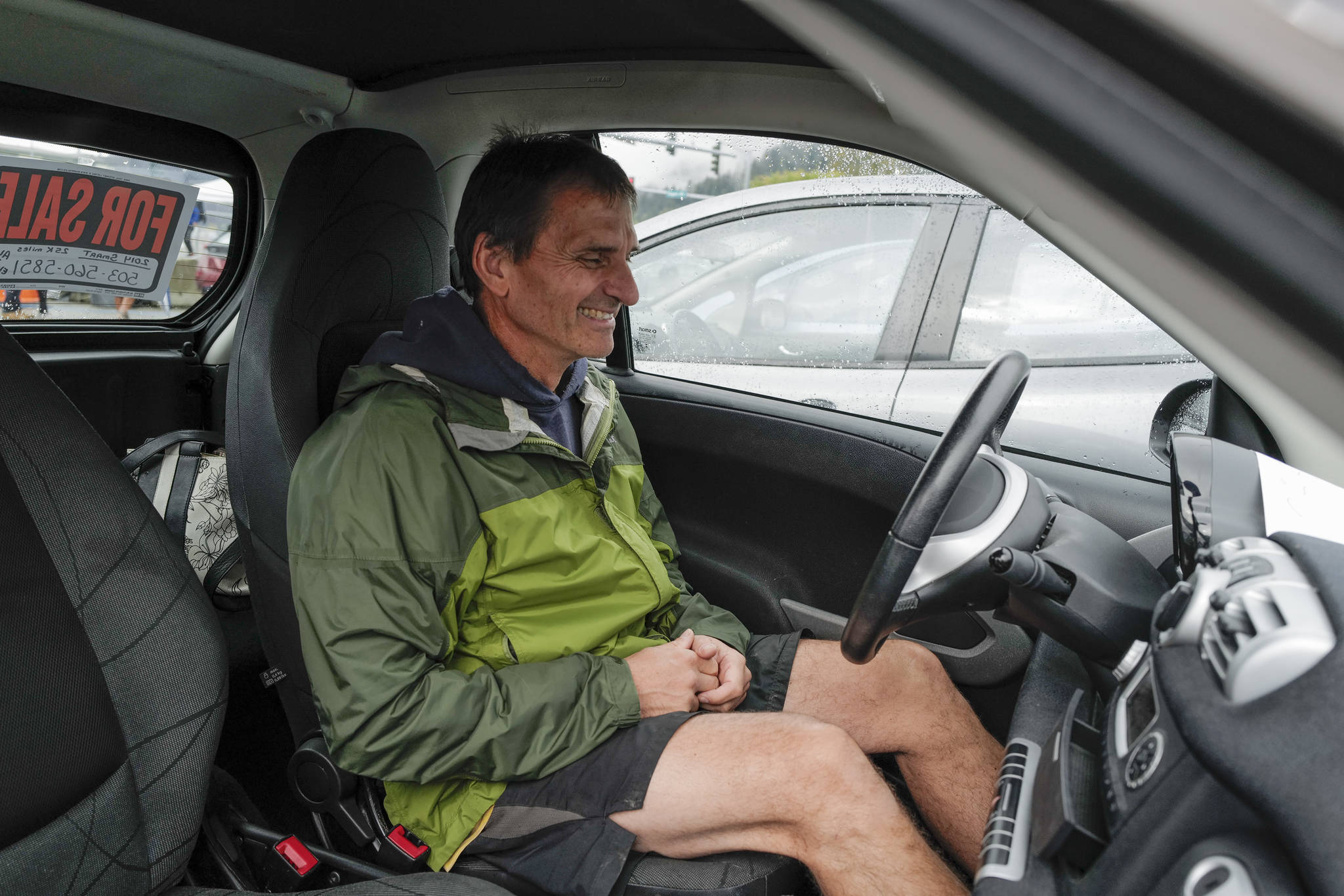 Arnold Liebelt tries out an electric Smart Car for size as Juneau residents meet for the Sixth Annual Electric Vehicle Juneau Roundup on Saturday, Sept. 21, 2019. (Michael Penn | Juneau Empire)