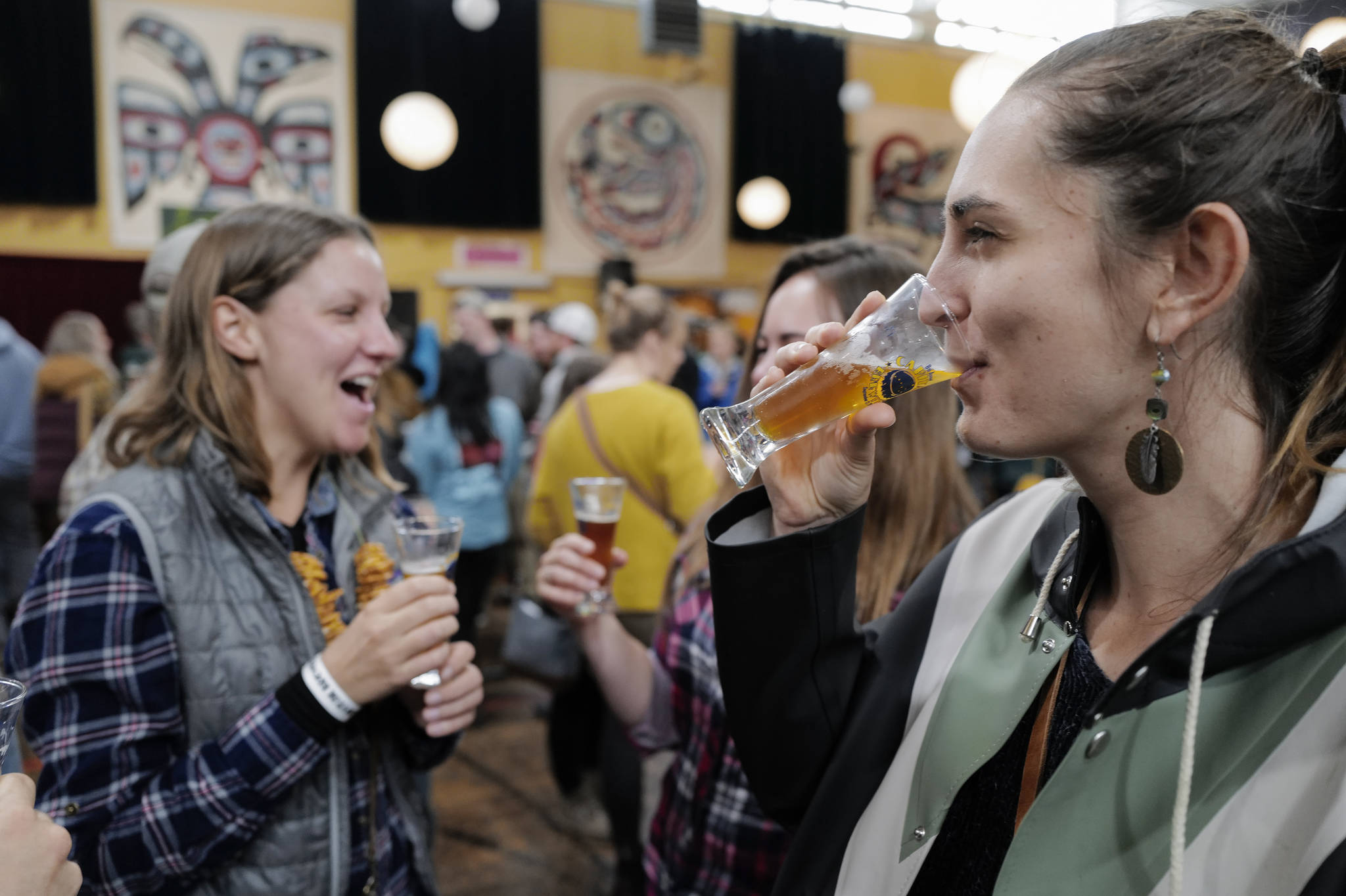 Malia Stauffer, right, drinks with friends at the Rotary Club of Juneau’s Eighth Annual Capital Brewfest at the Juneau Arts and Culture Center on Saturday, Sept. 21, 2019. Twenty brewing and distribution companies were on hand for the fundraiser to benefit the University of Alaska and Rotary’s service projects, scholarships, international youth exchanges and other project. The event was sold out with 900 tickets sold. (Michael Penn | Juneau Empire)