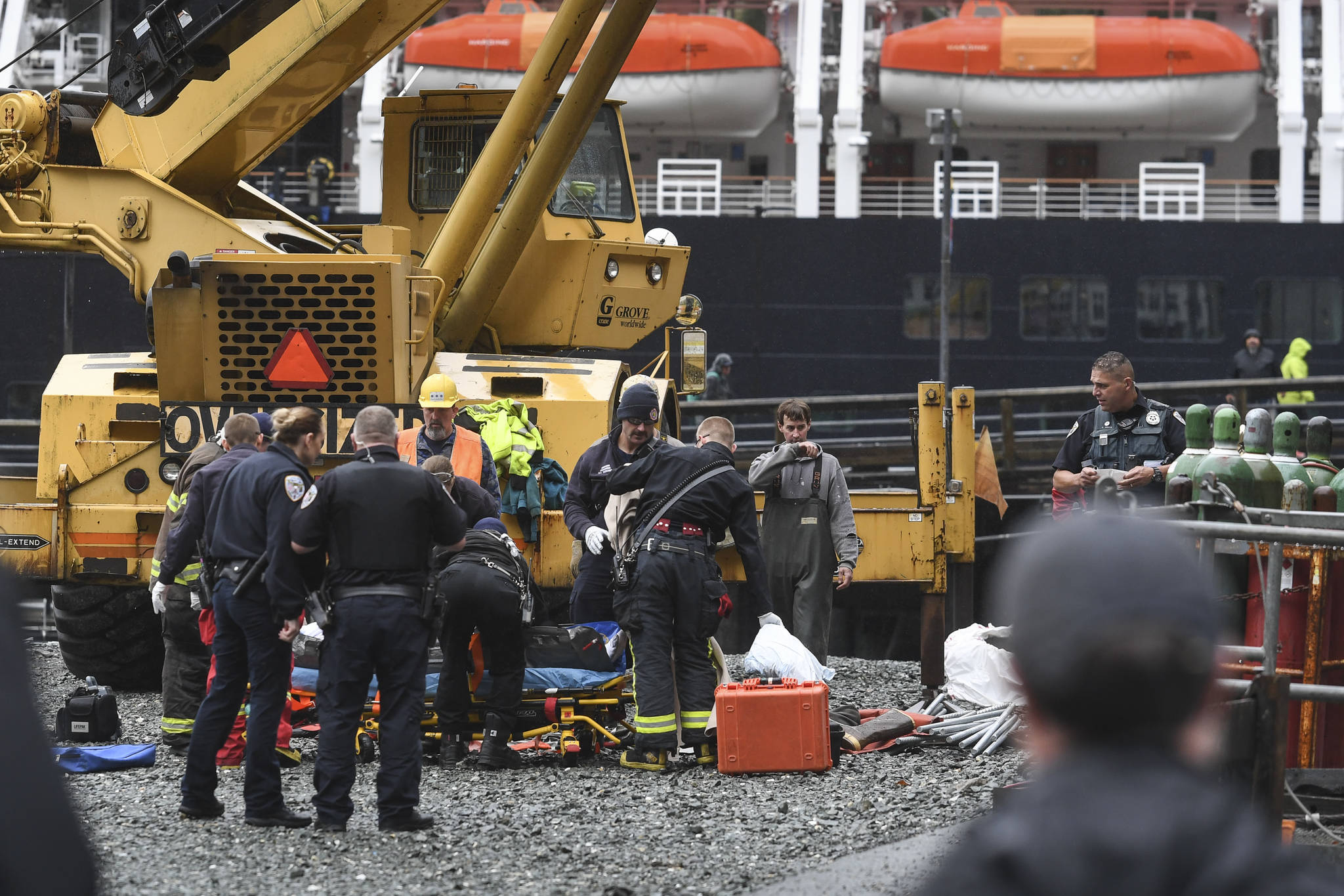 Juneau Police Department officers and Capital City Fire/Rescue personnel respond to an accident at the Downtown Public Library on Monday, Sept. 23, 2019. A construction worker was injured at a work site after a driver reportedly drove through the library parking barrier. (Michael Penn | Juneau Empire)