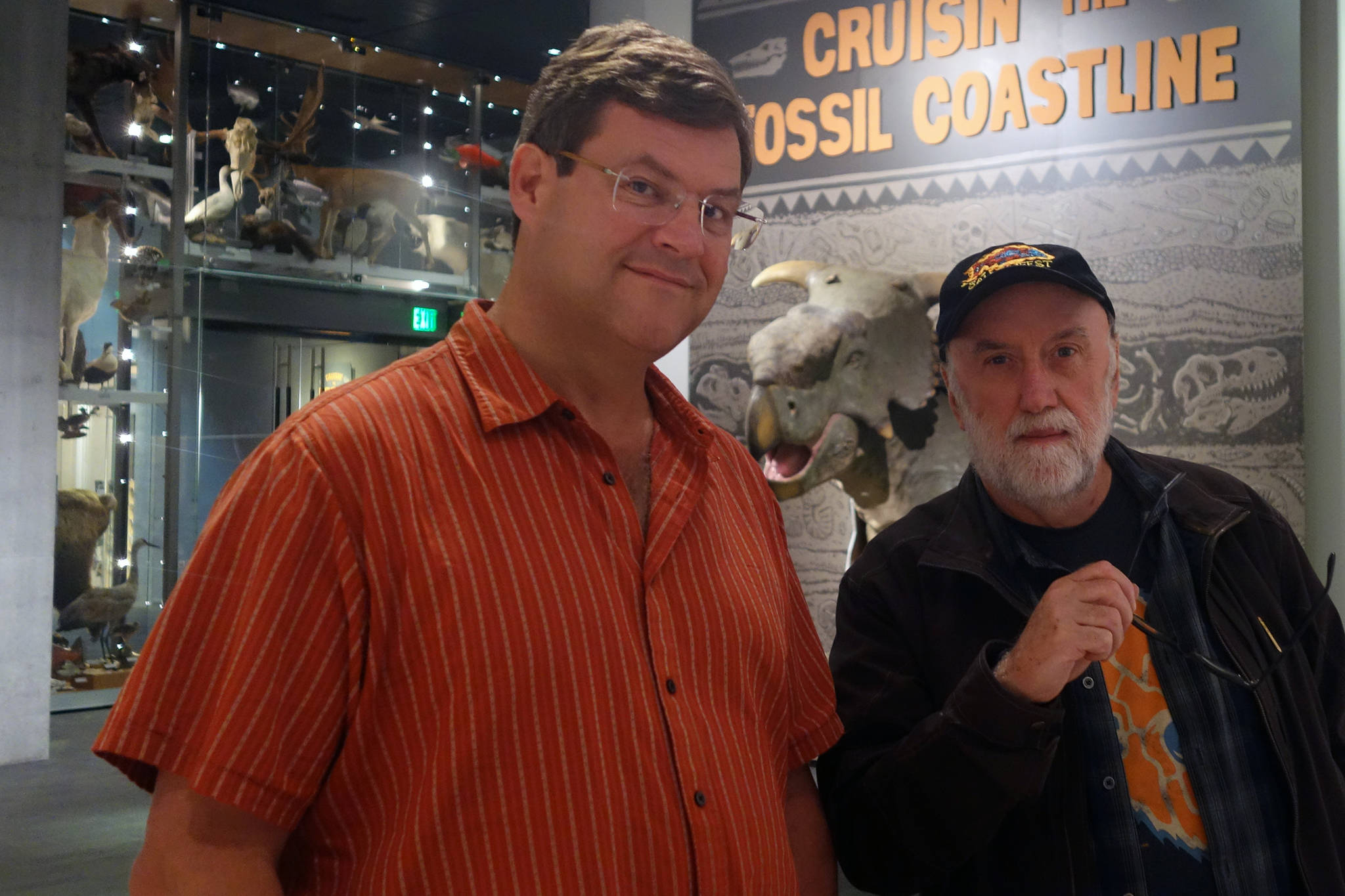 Smithsonian National Museum of Natural History Director Kirk Johnson and Ketchikan artist Ray Troll stand together in the Alaska State Museum. “Cruising’ the Fossil Coastline” is a traveling exhibition inspired by Troll and Johnson’s collaborative book. Johnson was in town Tuesday to talk at the museum. (Ben Hohenstatt | Capital City Weekly)