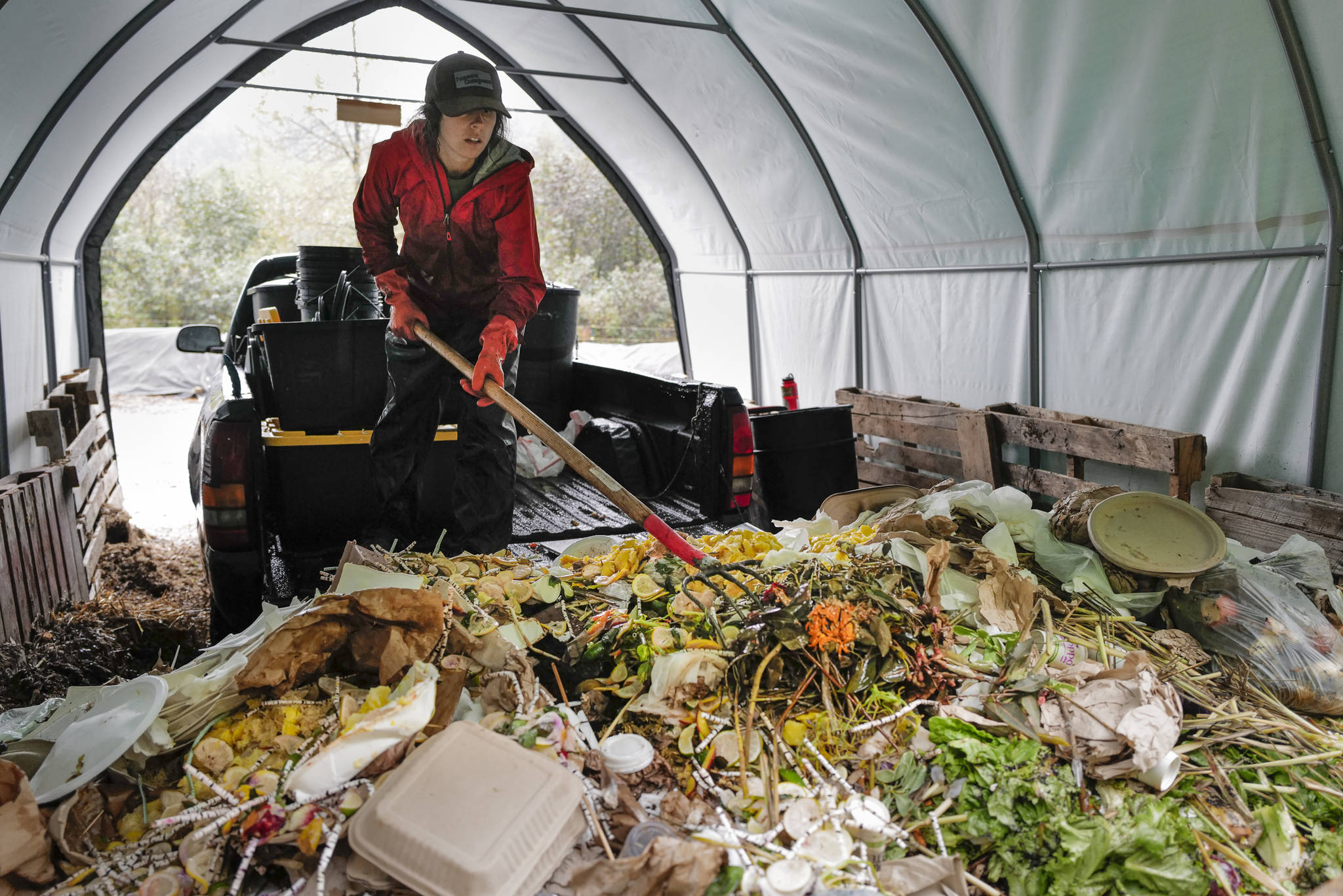 Lisa Daugherty, owner of Juneau Composts!, spreads out newly-collected food waste and compostable material at her half-acre site in Lemon Creek on Tuesday, Sept. 24, 2019. Daugherty is offering to take home owners’ leaves this fall. Daugherty has put up signs where to deposit leaves, but not plastic bags, at her business on Ralph’s Way. (Michael Penn | Juneau Empire)