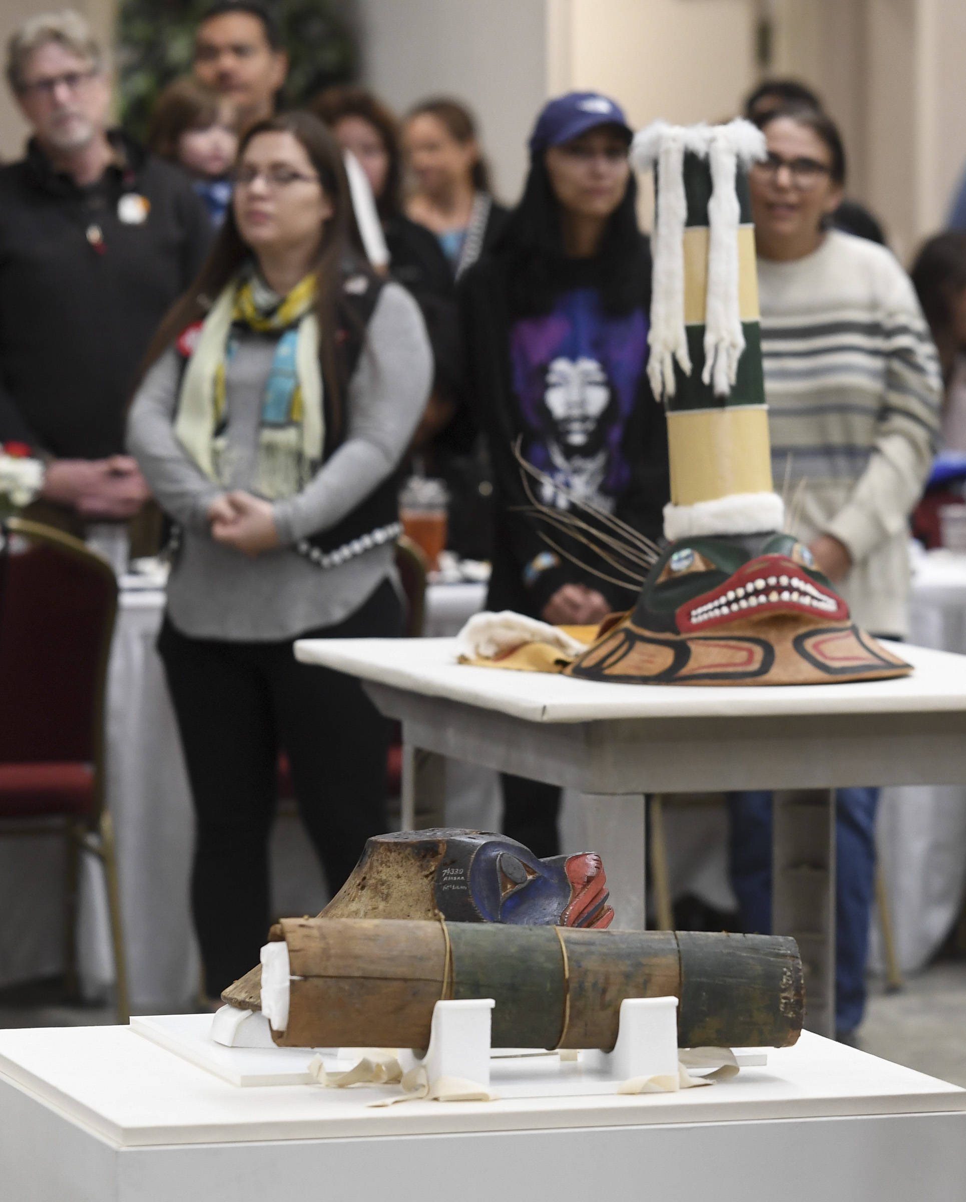 The original sculpin hat, bottom, sits next to a replica during a welcoming ceremony at Elizabeth Peratrovich Hall on Wednesday, Sept. 25, 2019. The original hat was collected from the Kiks.ádi Clan in Sitka in 1884. The Smithsonian Institution used a 3D digitization process to document the hat and constructed the hat using traditional materials. (Michael Penn | Juneau Empire)