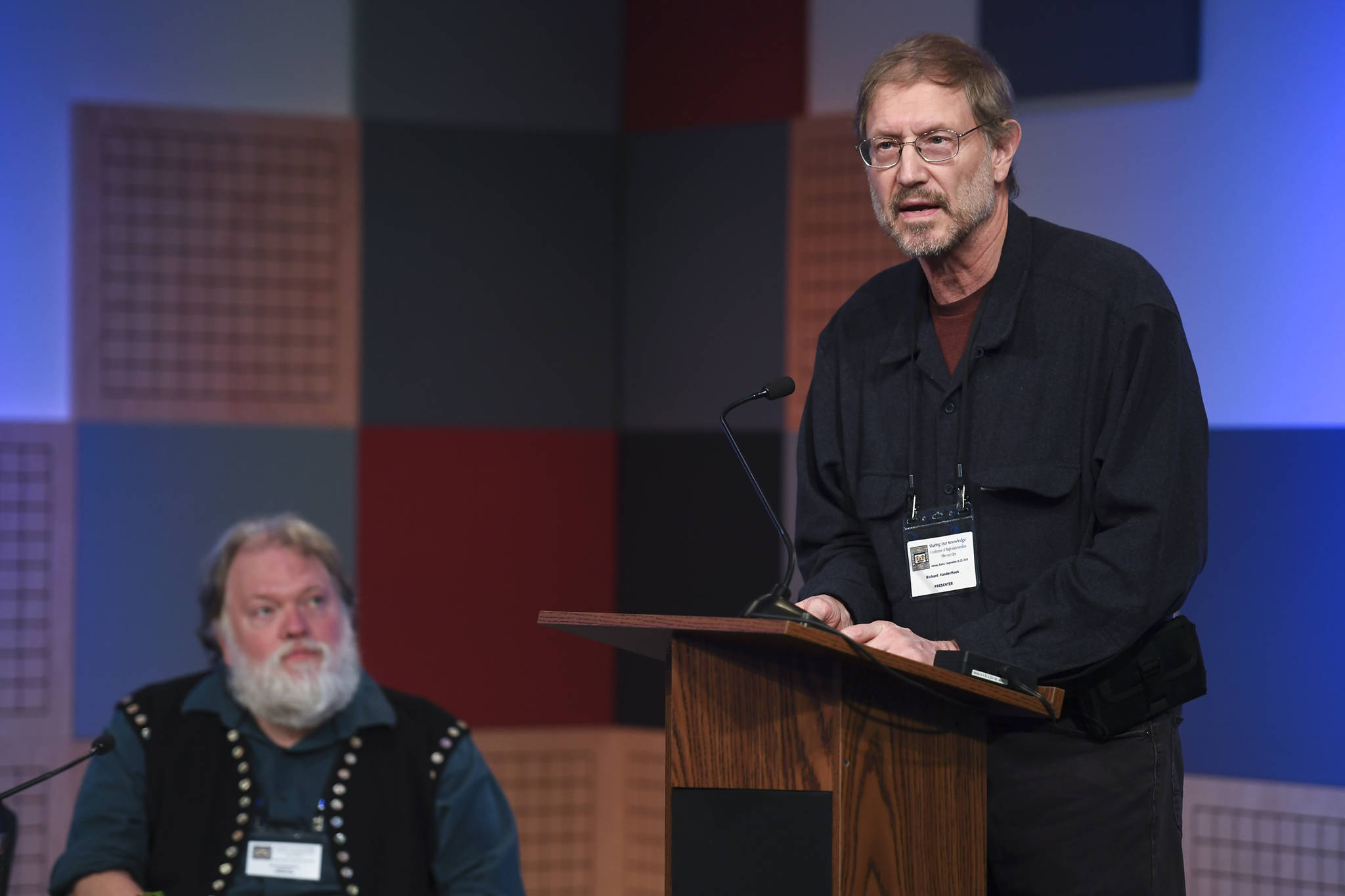 Richard VanderHoek, State Archaeologist with the Alaska Department of Natural Resources’ Office of History and Archaeology, right, and Steve Henrikson, curator of collections at the Alaska State Museum, give a presentation on spear throwing at KTOO as part of the Sharing Our Knowledge conference on Friday, Sept. 27, 2019. (Michael Penn | Juneau Empire)