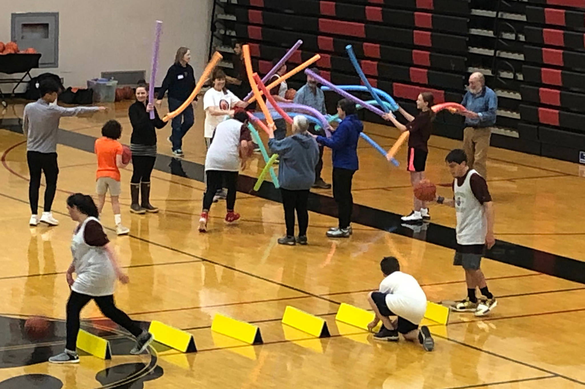 Coaches wave foam noodles as campers try to dribble through them without losing the ball at the I Did, You Can! basketball camp on Sunday, Sept. 29, 2019. (Courtesy Photo | Janette Gagnon)
