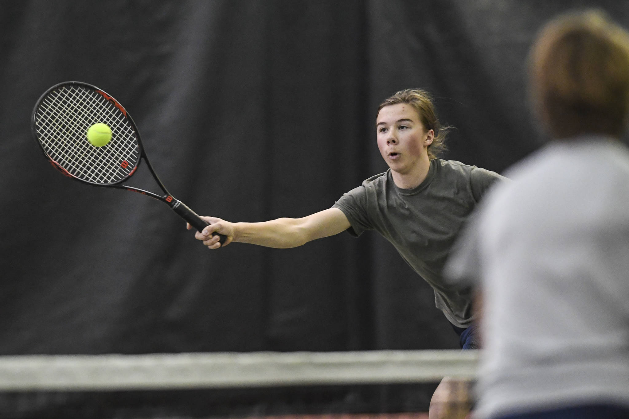 Liam Penn returns a volley as he plays in a boys doubles’ semifinal with partner Callan Smith against William Smoker and Will Rehfeldt during the Region V Tennis Tournament at The Alaska Club/JRC on Saturday, Sept. 28, 2019. Smoker/Rehfeldt won 7-6, 6-2. (Michael Penn | Juneau Empire)