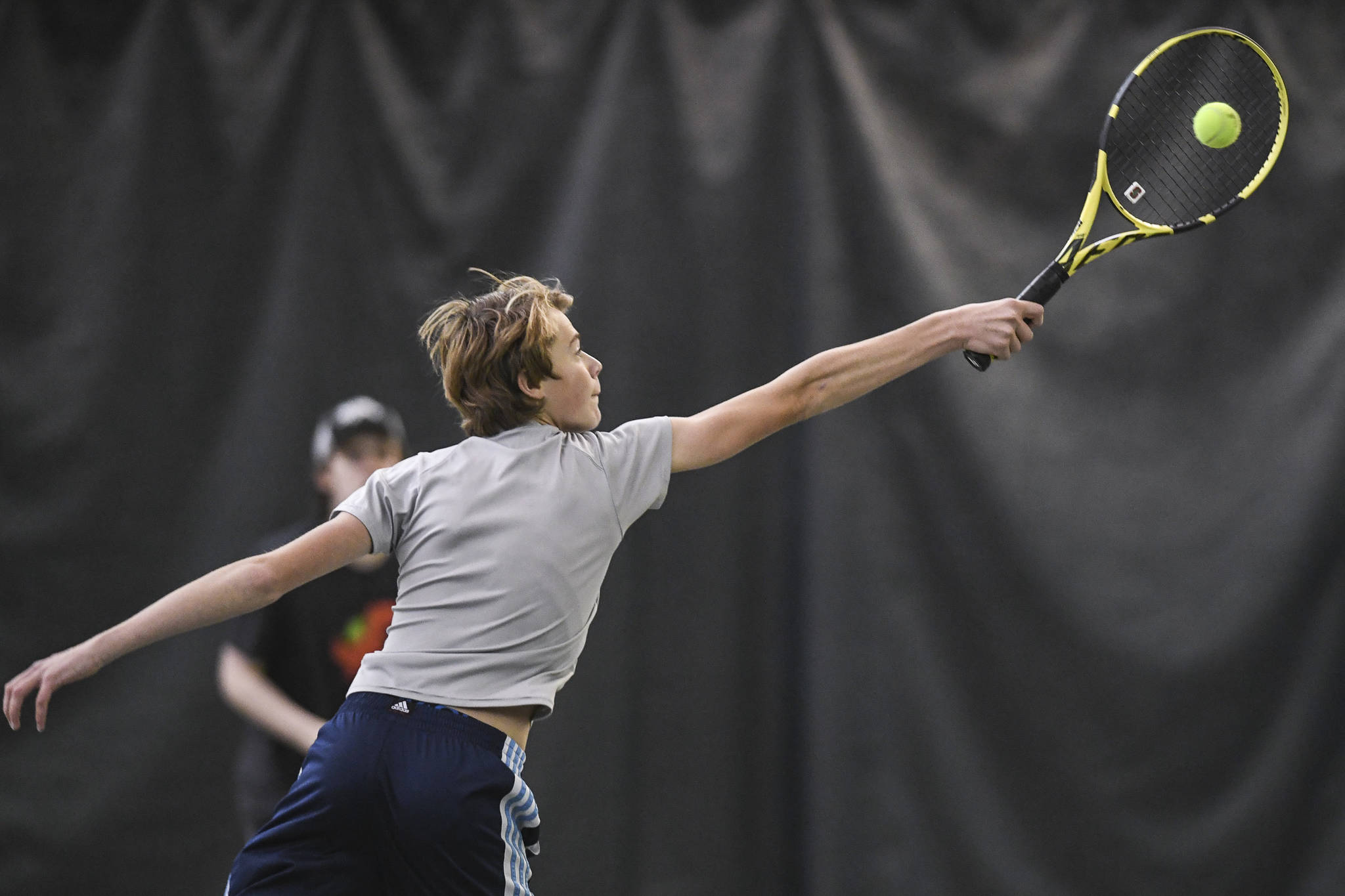 Will Rehfeldt returns a volley in a boys doubles’ semifinal with partner William Smoker against Liam Penn and Callan Smith during the Region V Tennis Tournament at The Alaska Club/JRC on Saturday, Sept. 28, 2019. Smoker/Rehfeldt won 7-6, 6-2. (Michael Penn | Juneau Empire)
