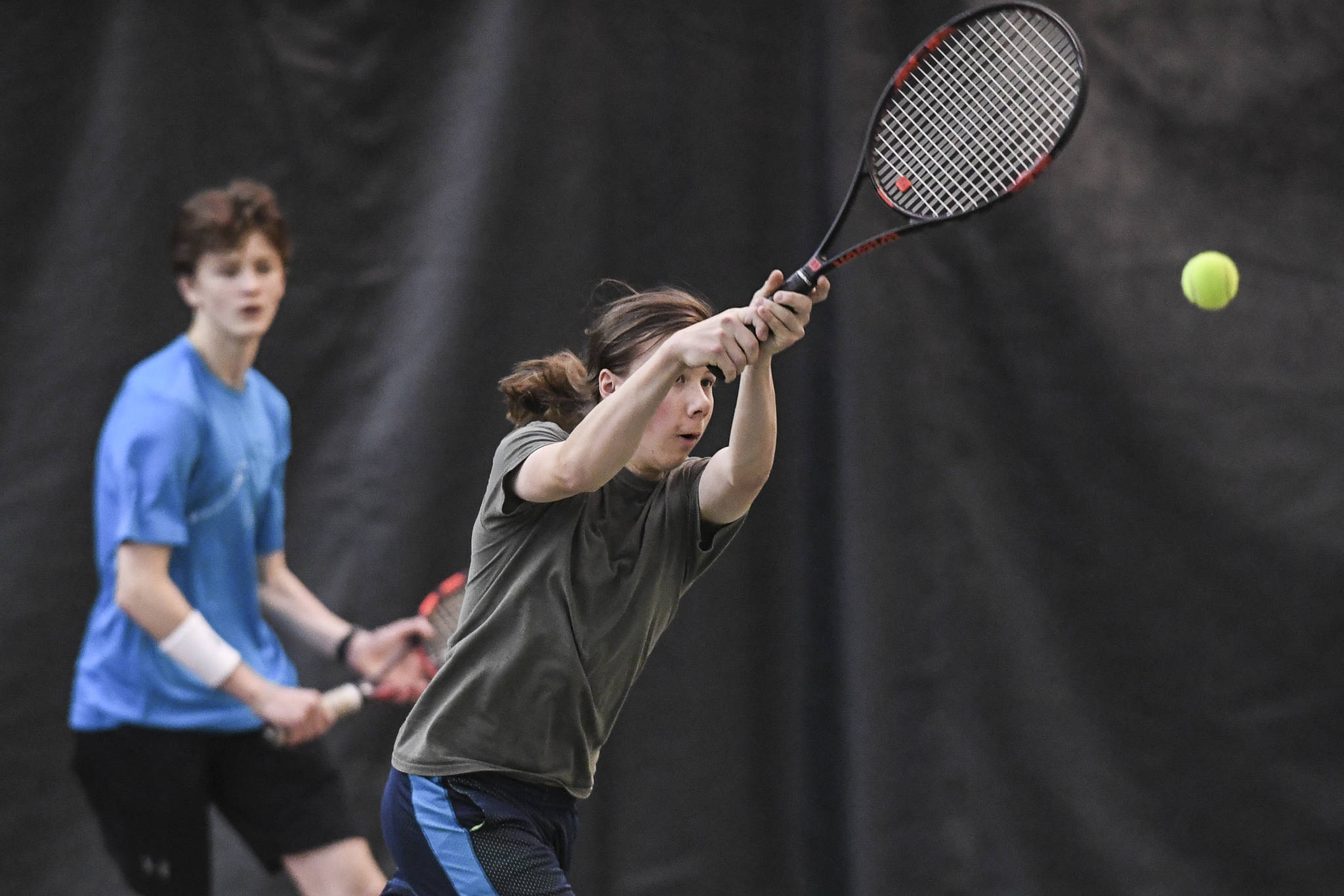 Liam Penn returns a backhand as he plays in a boys doubles’ semifinal with partner Callan Smith against William Smoker and Will Rehfeldt during the Region V Tennis Tournament at The Alaska Club/JRC on Saturday, Sept. 28, 2019. Smoker/Rehfeldt won 7-6, 6-2. (Michael Penn | Juneau Empire)