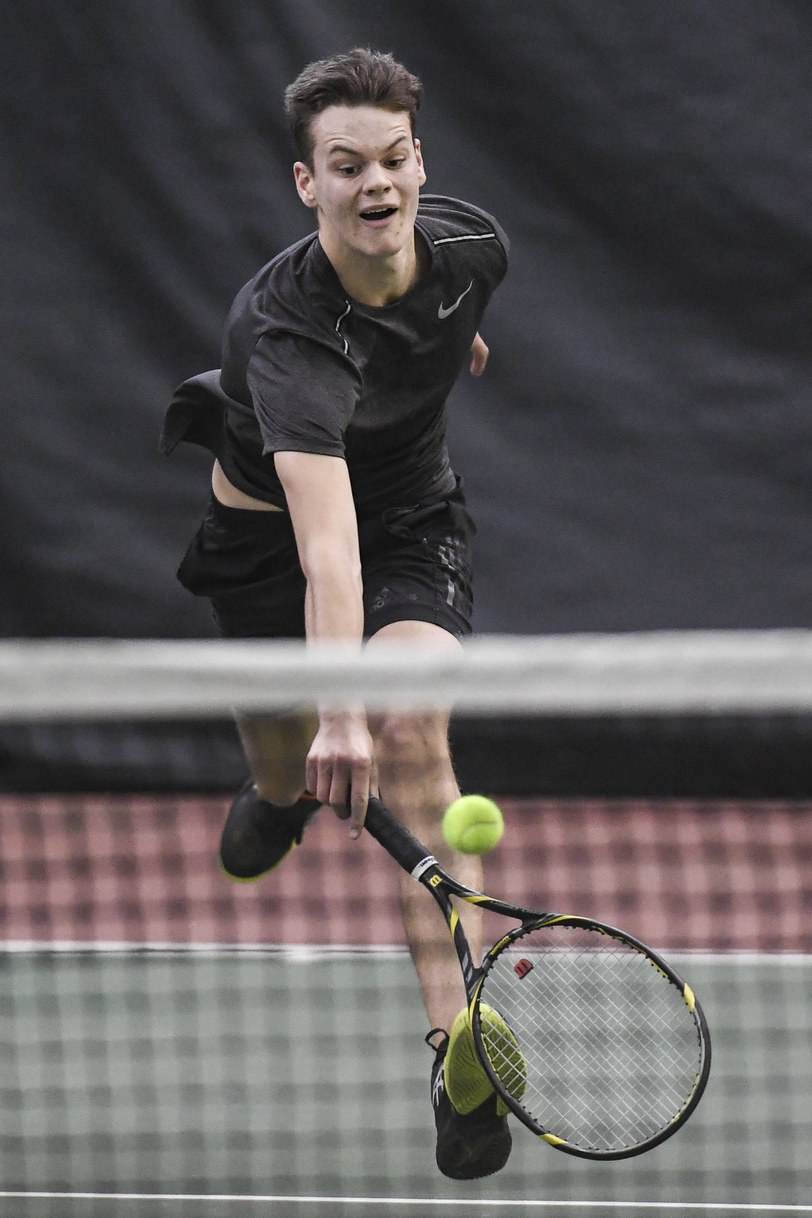 Kevin Kooistra chases down a ball against William Smoker in the boys singles’ final during the Region V Tennis Tournament at The Alaska Club/JRC on Sunday, Sept. 29, 2019. Kooistra won 6-0, 6-0. (Michael Penn | Juneau Empire)