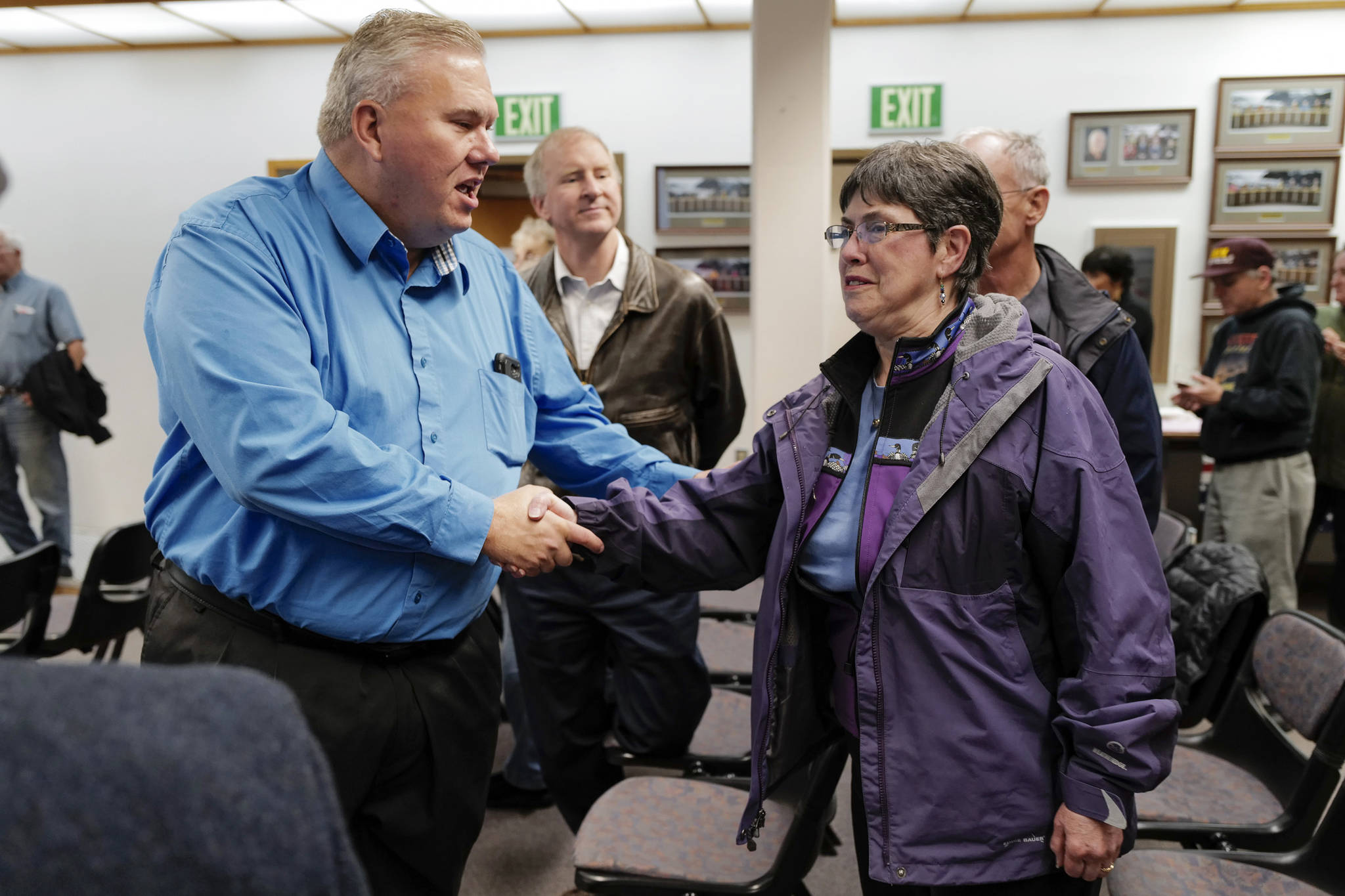 School board candidates Emil Mackey and Deedie Sorenson greet each other at City Hall on Tuesday, Oct. 1, 2019. (Michael Penn | Juneau Empire)