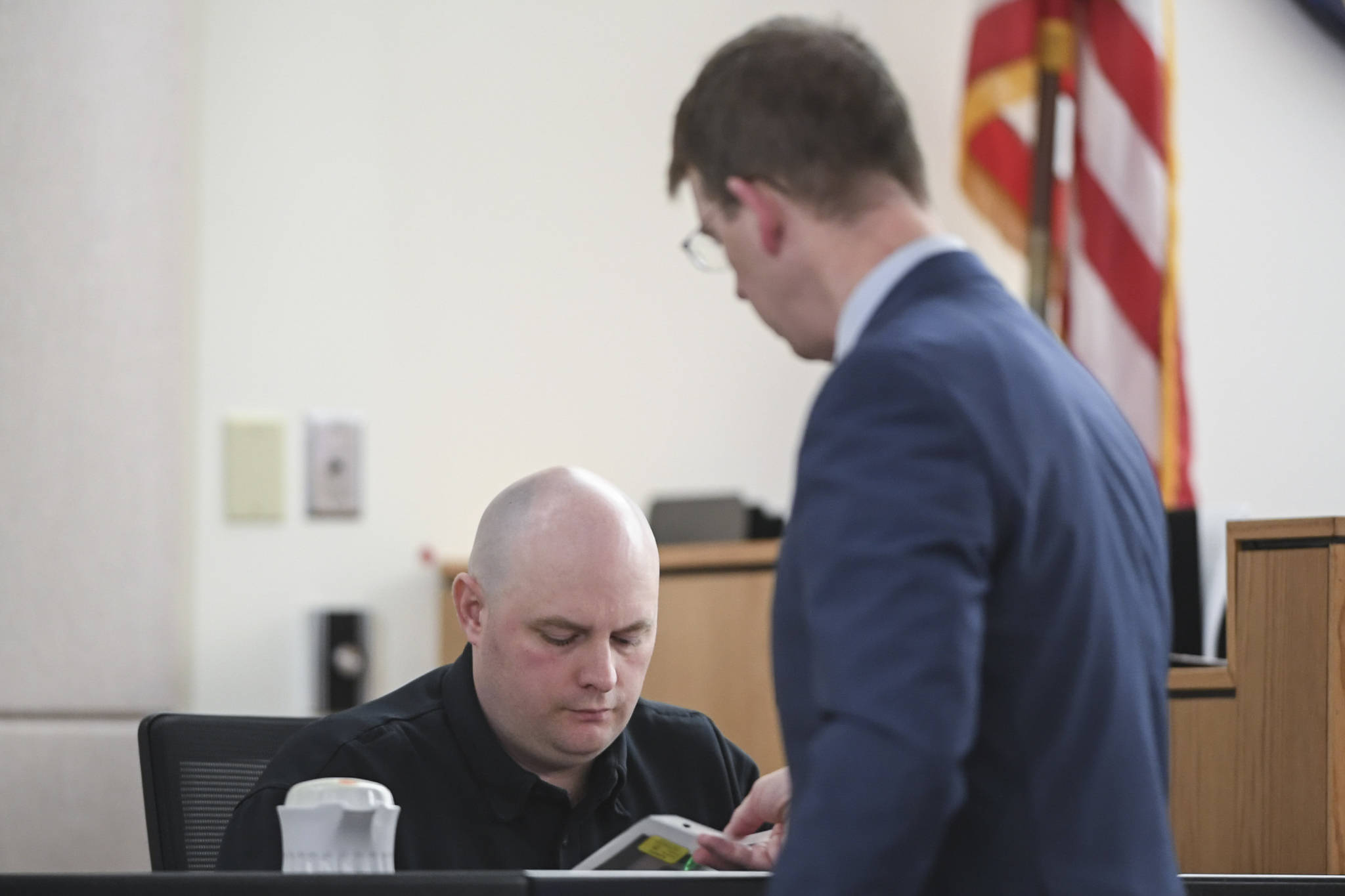 Prosecuting Attorney John Darnall, from the Office of Special Prosecutions, right, shows pictures of recovered bullets and their casings to Juneau Police Department Sgt. Matt DuBois during the double murder trial of Laron Carlton Graham in Juneau Superior Court on Monday, Sept. 30, 2019. Graham is charged with two counts of first-degree murder for the November 2015 shooting deaths of 36-year-old Robert H. Meireis and 34-year-old Elizabeth K. Tonsmeire. (Michael Penn | Juneau Empire)