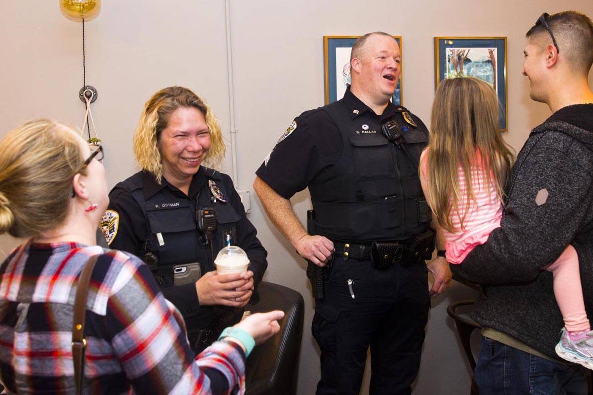 Juneau Police Department Officer Rosie Ostman and Sgt. Brian Dallas talk with Juneau residents at Sacred Grounds on Oct. 2, 2019, National Coffee with a Cop Day. The annual event promotes positive interactions with community members and law enforcement agencies. (Michael S. Lockett | Juneau Empire)