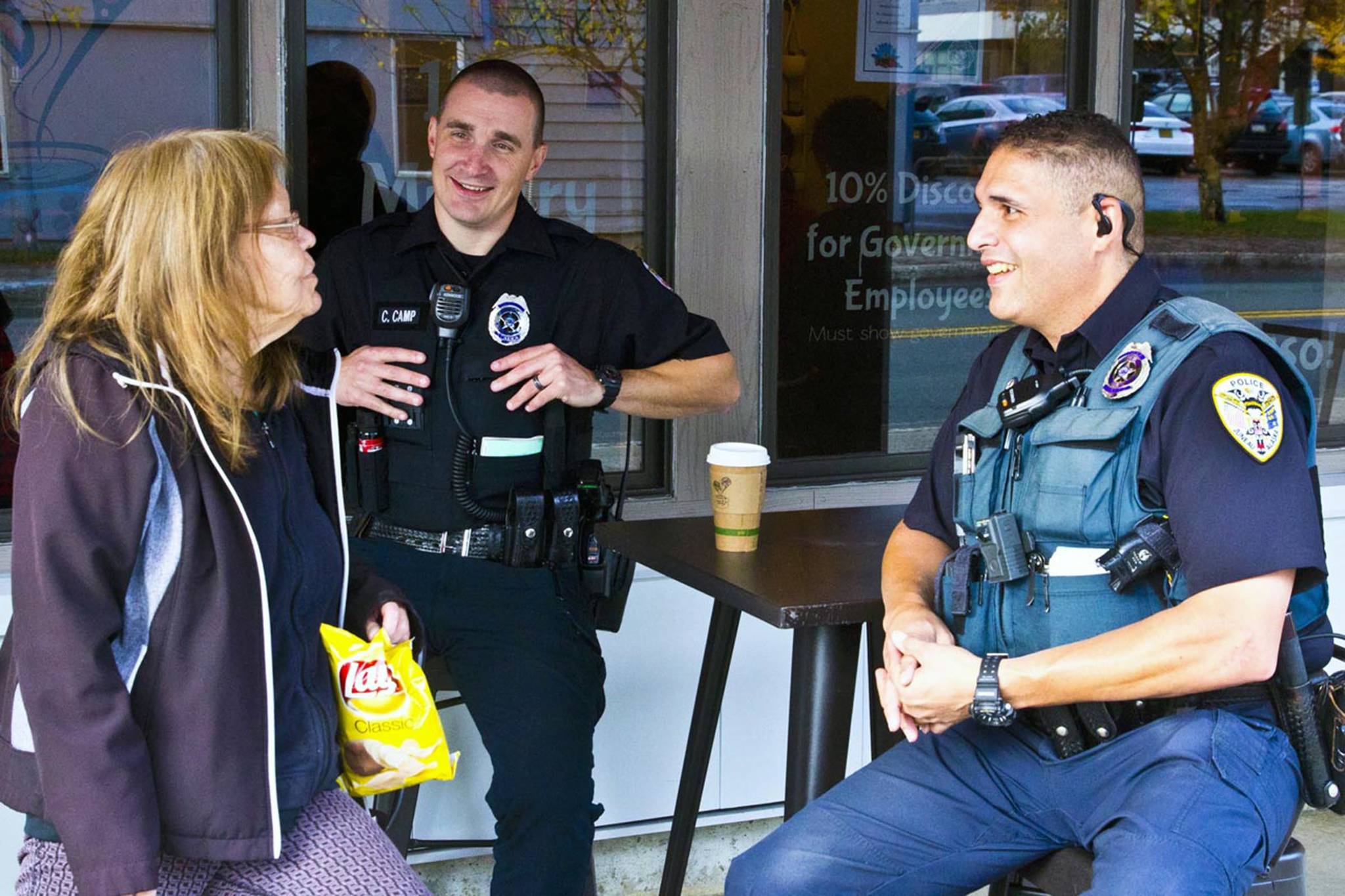 Juneau Police Department Officers Casey Camp and Ken Colon took part in Coffee with a Cop at Sacred Grounds, a yearly event where they hang out with Juneau residents in a coffee shop, on Oct. 2, 2019. (Michael S. Lockett | Juneau Empire)