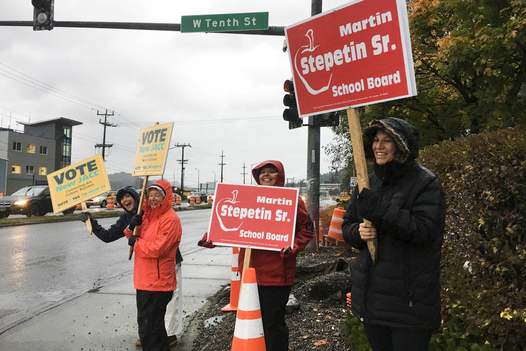 Supporters of Martin Stepetin Sr.’s bid for a seat on the school board and Proposition 3 wave signs in the intersection of Egan Drive and the Juneau-Douglas Bridge. Voting is from 7 a.m. to 8 p.m. on Tuesday, Oct. 1, 2019. (Michael S. Lockett | Juneau Empire)
