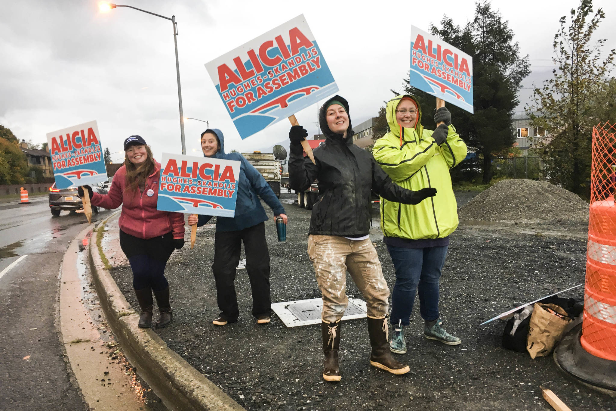 Alicia Hughes-Skandijs and some of her supporters wave signs in the intersection of Egan Drive and the Juneau-Douglas Bridge. Voting is from 7 a.m. to 8 p.m. on Tuesday, Oct. 1, 2019. (Michael S. Lockett | Juneau Empire)
