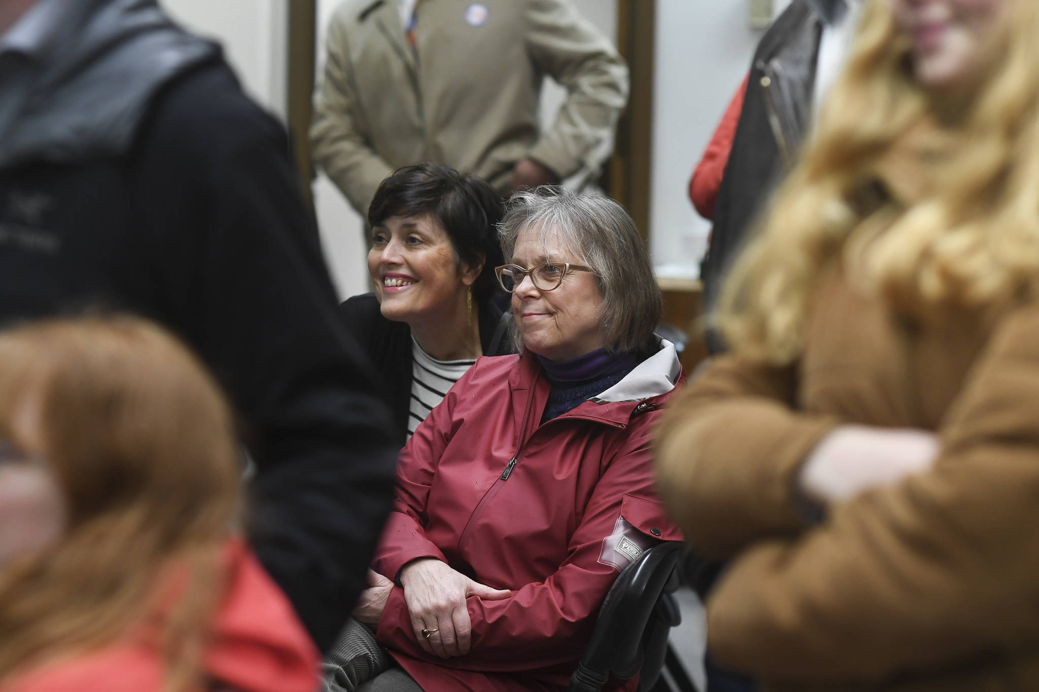 Nancy DeCherney, executive director of the Juneau Arts and Humanities Council, and Ballot Measure 3 Campaign Manager Minta Montalbo, left, watch results come in at City Hall on Tuesday, Oct. 1, 2019. (Michael Penn | Juneau Empire)
