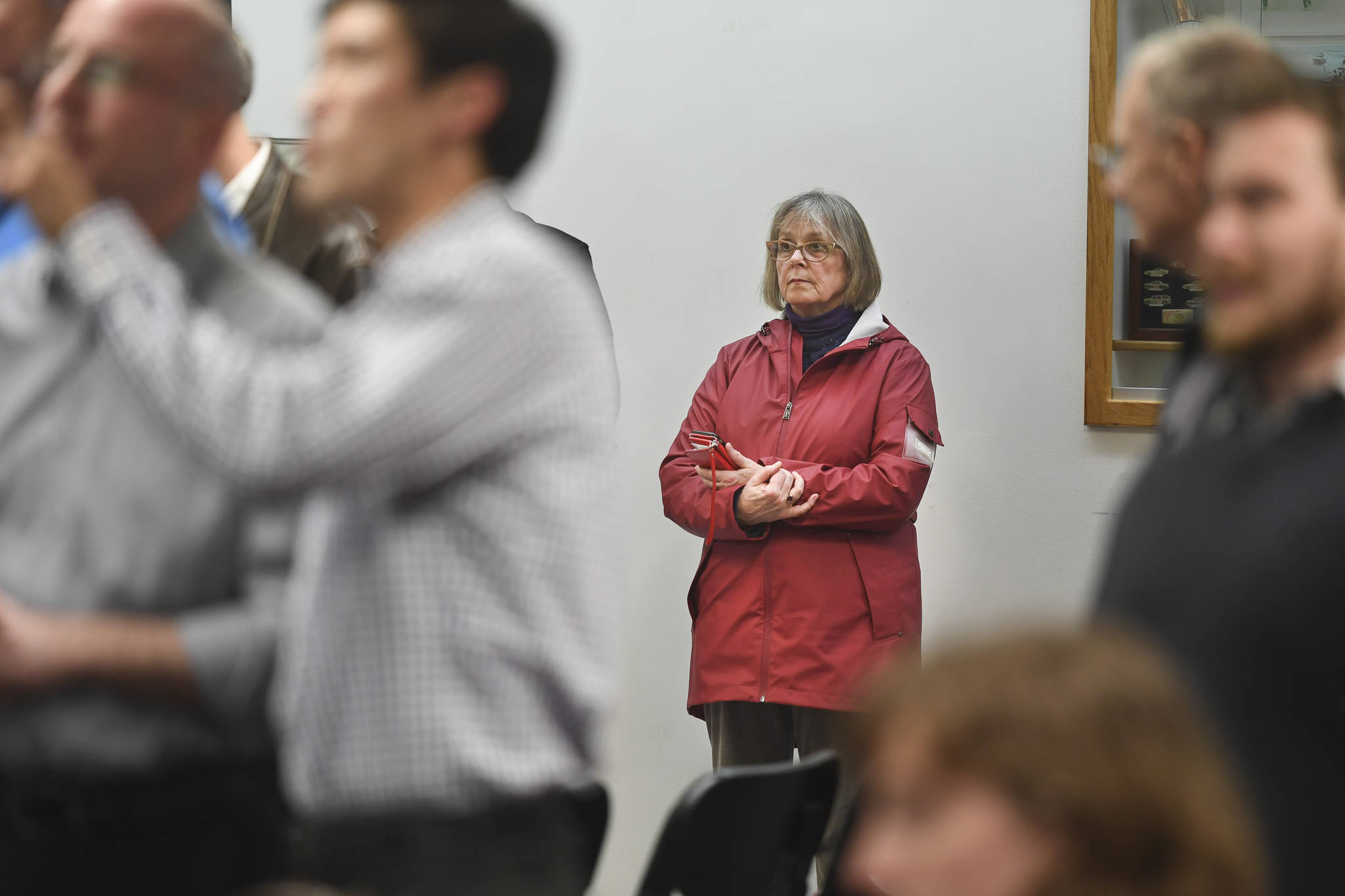Nancy DeCherney, executive director of the Juneau Arts and Humanities Council, watches results come in at City Hall on Tuesday, Oct. 1, 2019. (Michael Penn | Juneau Empire)