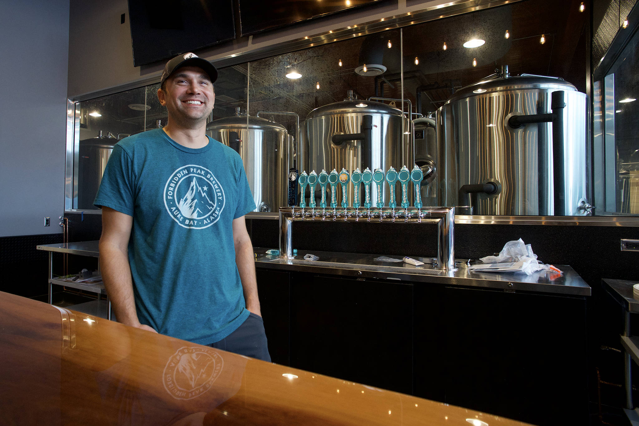 Co-owner Skye Stekoll stands behind a new bar as the Forbidden Peak Brewery nears completion on Thursday, Oct. 3, 2019. The Auke Bay brewery opens Saturday, Oct. 12. (Michael Penn | Juneau Empire)