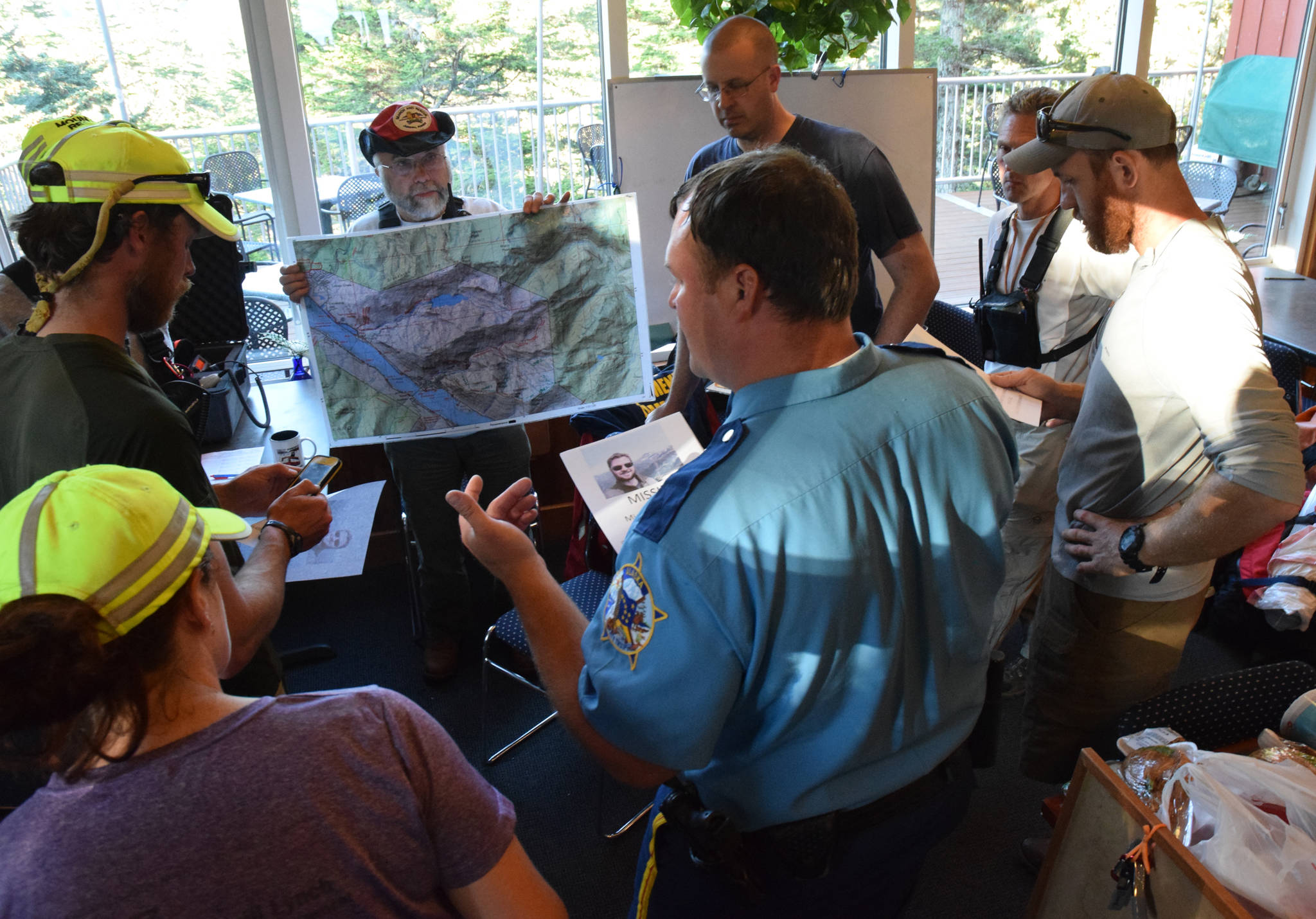 Alaska State Trooper Joshua Bentz briefs members of Juneau Mountain Rescue and SEADOGS Sunday, July 5, 2015 during the search for missing hiker Michael Blaisdell. (Michael Penn | Juneau Empire)