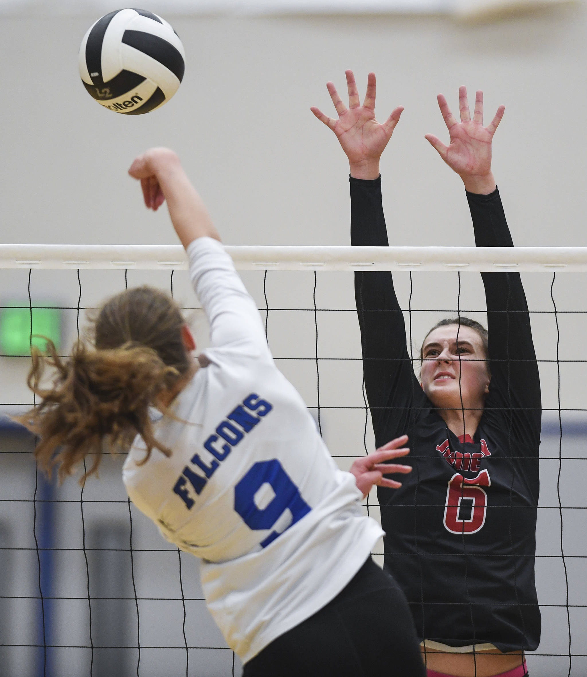 Juneau-Douglas’ Addie Prussing, right, attempts a block against Thunder Mountain’s Sophia Harvey at Thunder Mountain High School on Friday, Oct. 4, 2019. (Michael Penn | Juneau Empire)