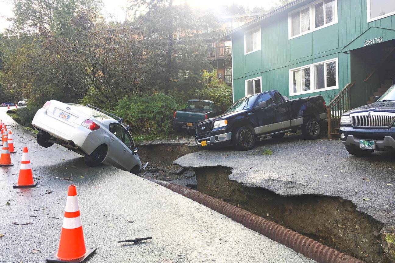 Emily Weir’s car fell into chasm washed away on John Street in Douglas the evening of Oct. 5, 2015. Heavy rains in Juneau washed out roads, caused mudslides and damaged houses. (Michael S. Lockett | Juneau Empire)