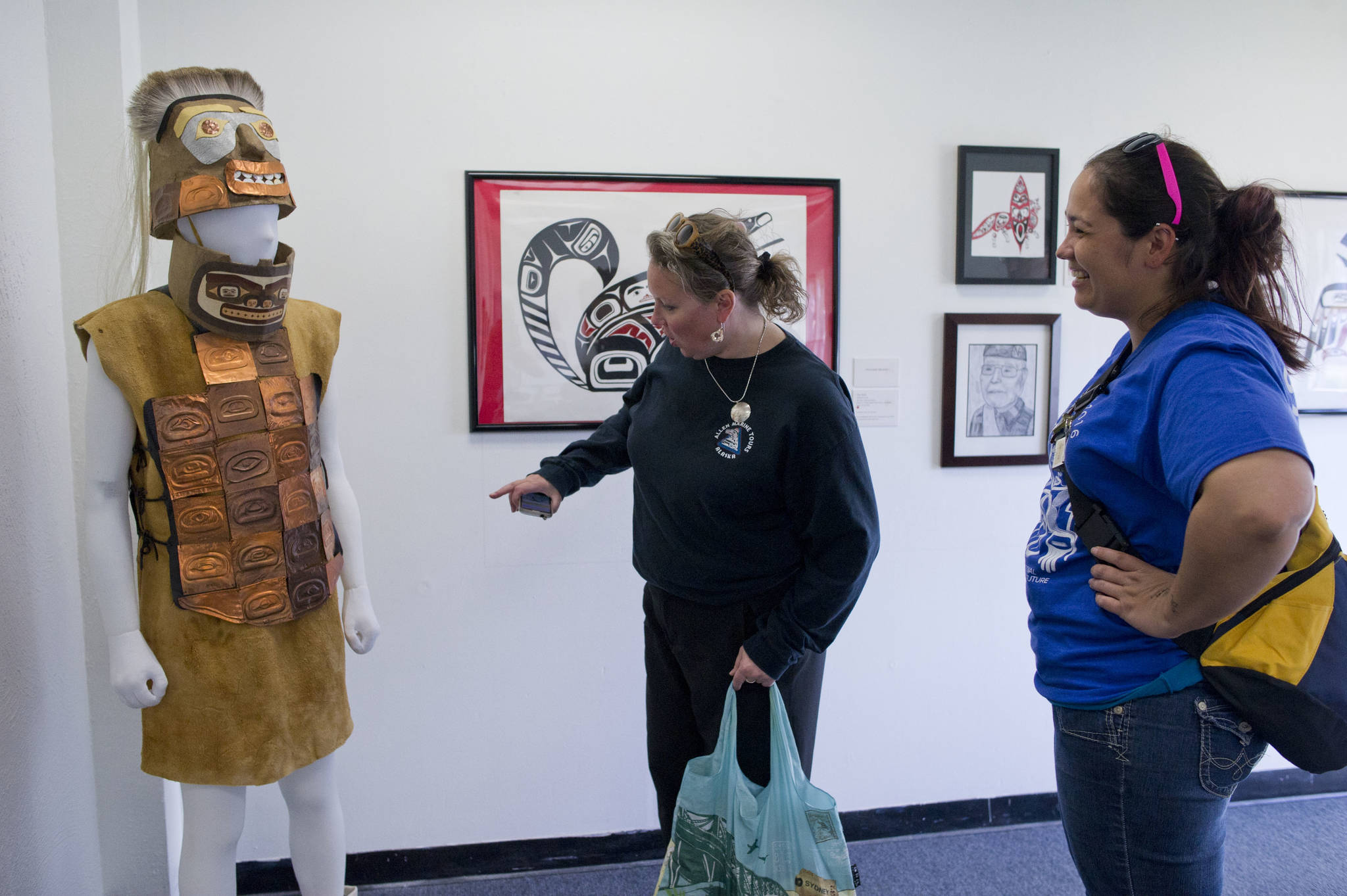 Divina Cole, right, and Kelly Coursey Gray admire the warrior’s helmet and armor made by 61 students at Dzantik’i Heeni Middle School that won Juried Youth Art Award at the Juneau Arts and Culture Center as part of Celebration 2016. The juried art show is accepting applications. (Michael Penn | Juneau Empire File)