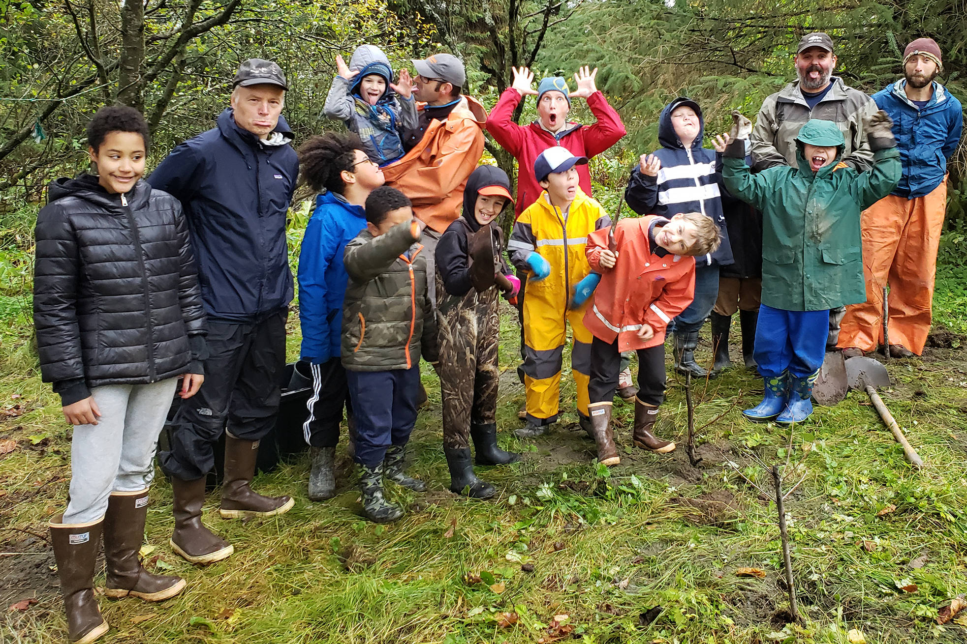 Cub Scouts from Pack 6 and 10 pose with staff with the Southeast Alaska Watershed Coalition, including restoration biologist John Hudson, second from left, and executive director Rob Cadmus, far right, outside the Super 8 by Wyndham in the Mendenhall Valley. The two troops helped plant over 100 trees between Jordan Creek and the hotel. (Courtesy Photo | Shannon Seifert)