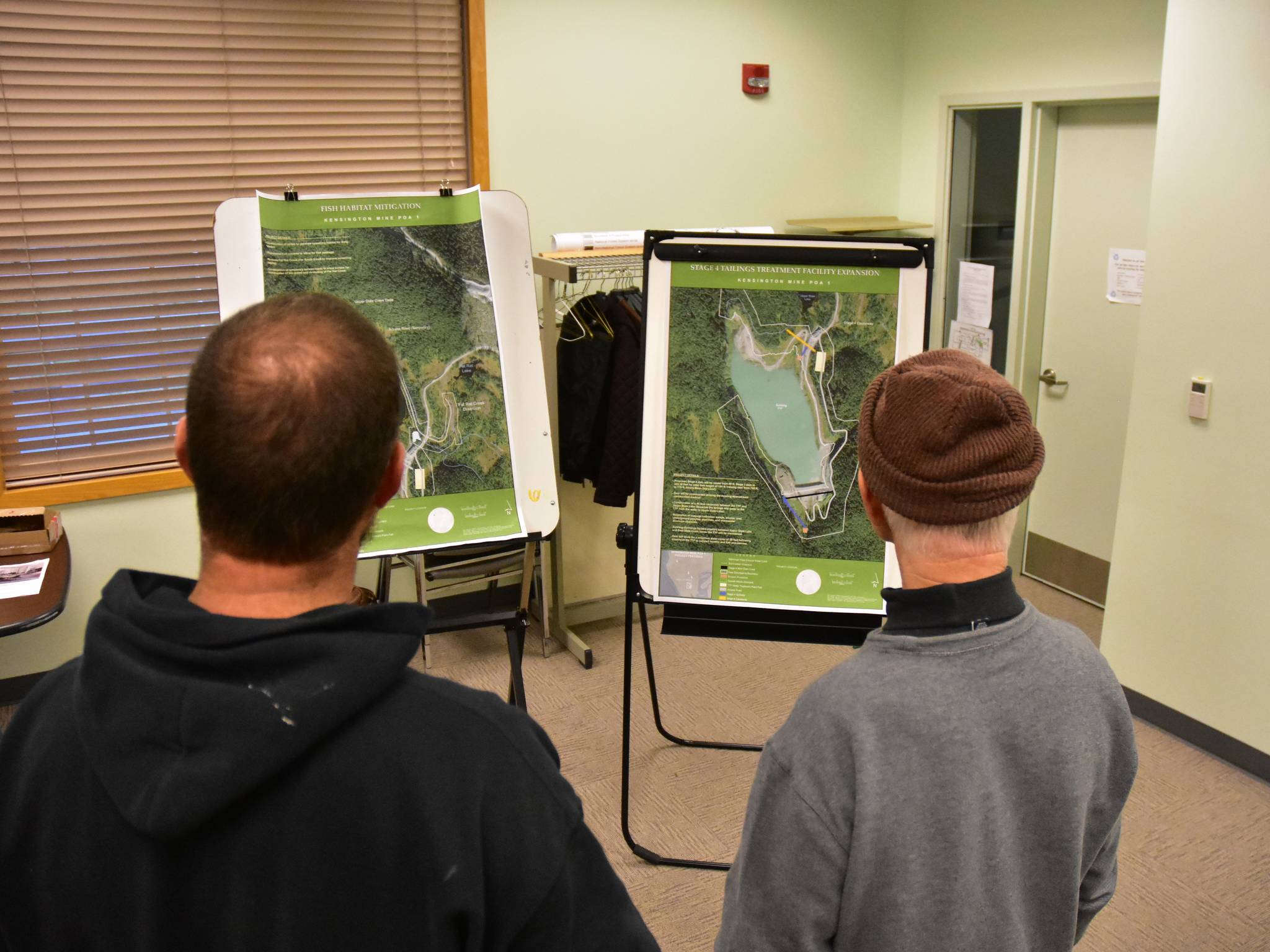 Members of the public examine maps of the proposed expansion to Coeur Alaska’s Kensington Mine facilities at the Juneau Ranger District Station on Oct. 8, 2019 (Peter Segall | Juneau Empire)