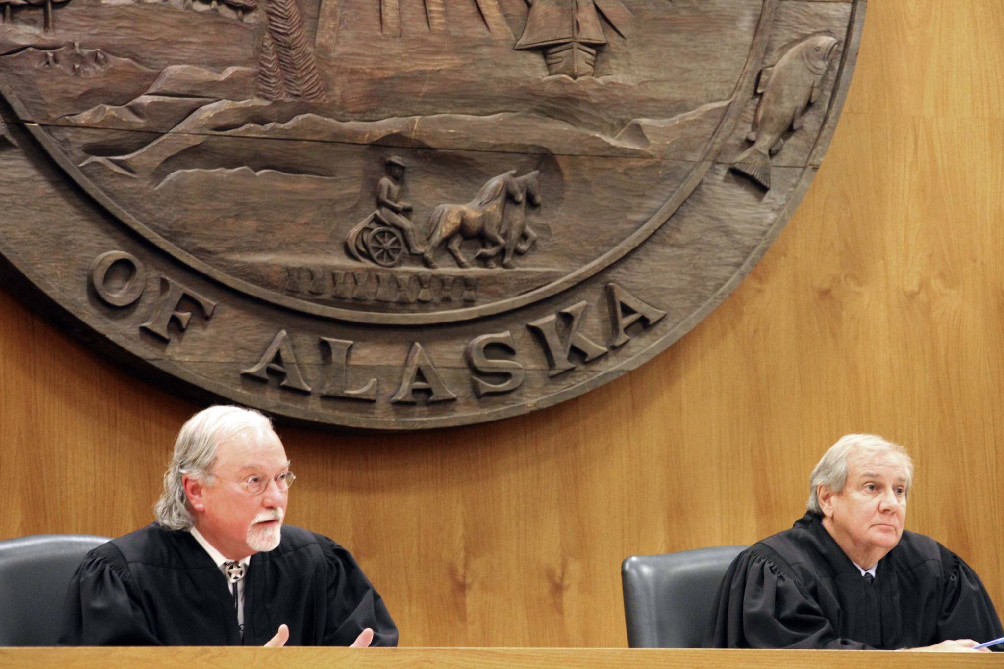Alaska Supreme Court Justices Craig Stowers, left, and Daniel Winfree listen to arguments in a lawsuit that claims state policy on fossil fuels is harming the constitutional right of young Alaskans to a safe climate Wednesday in Anchorage. Sixteen Alaska youths in 2017 sued the state, claiming that human-caused greenhouse gas emission leading to climate change is creating long-term, dangerous health effects. They lost in Superior Court, but appealed to Alaska’s highest court. (AP Photo | Mark Thiessen)