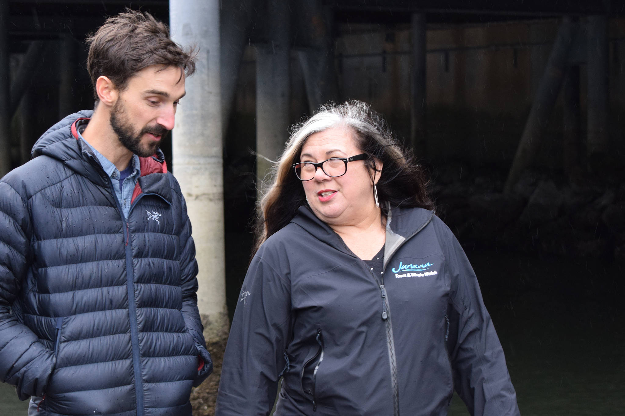 Juneau Tours & Whale Whale General Manager Serene Hutchinson talks with Alaska Shore Tours owner Drew Fortner on the Juneau waterfront on Wednesday, Oct. 9, 2019. (Nolin Ainsworth | Juneau Empire)