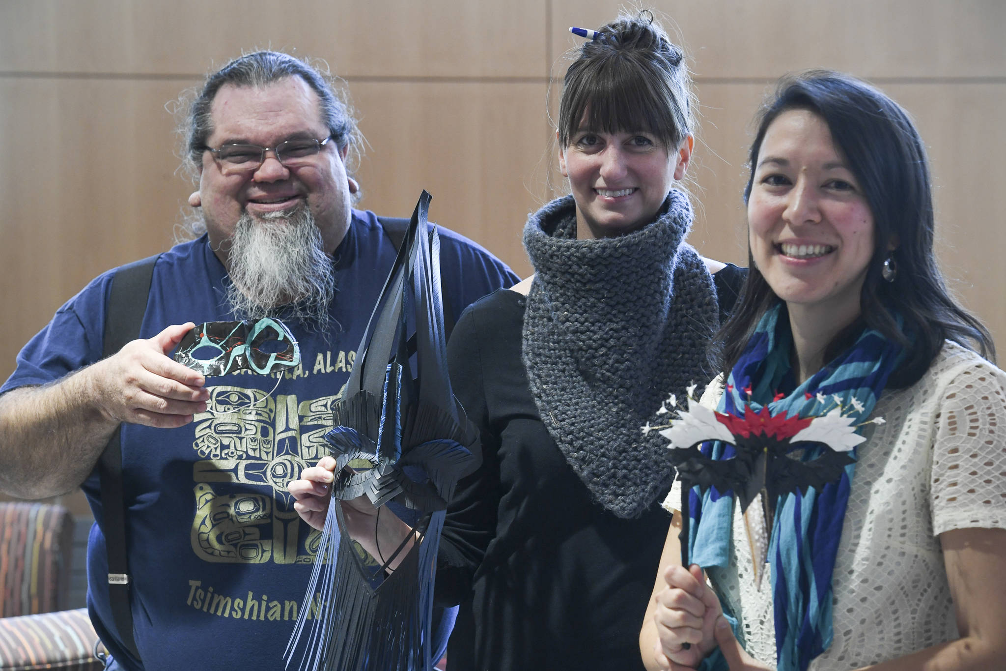 Artists Abel Ryan, left, Tanna Peters, center, and Nobu Koch hold masks they made for the Mask-erade fundraising event put on by the Friends of the Alaska State Library, Archives and Museum to be held on Saturday, Oct. 19, from 8 to 11 p.m. Nine artists created masks to be auctioned off at the dance. Live music will be provided by Susu and the Prophets. Masks can be made Saturday 1-3:30 p.m. Watch the video below to learn more about the masks and the artist who made them. (Michael Penn | Juneau Empire)