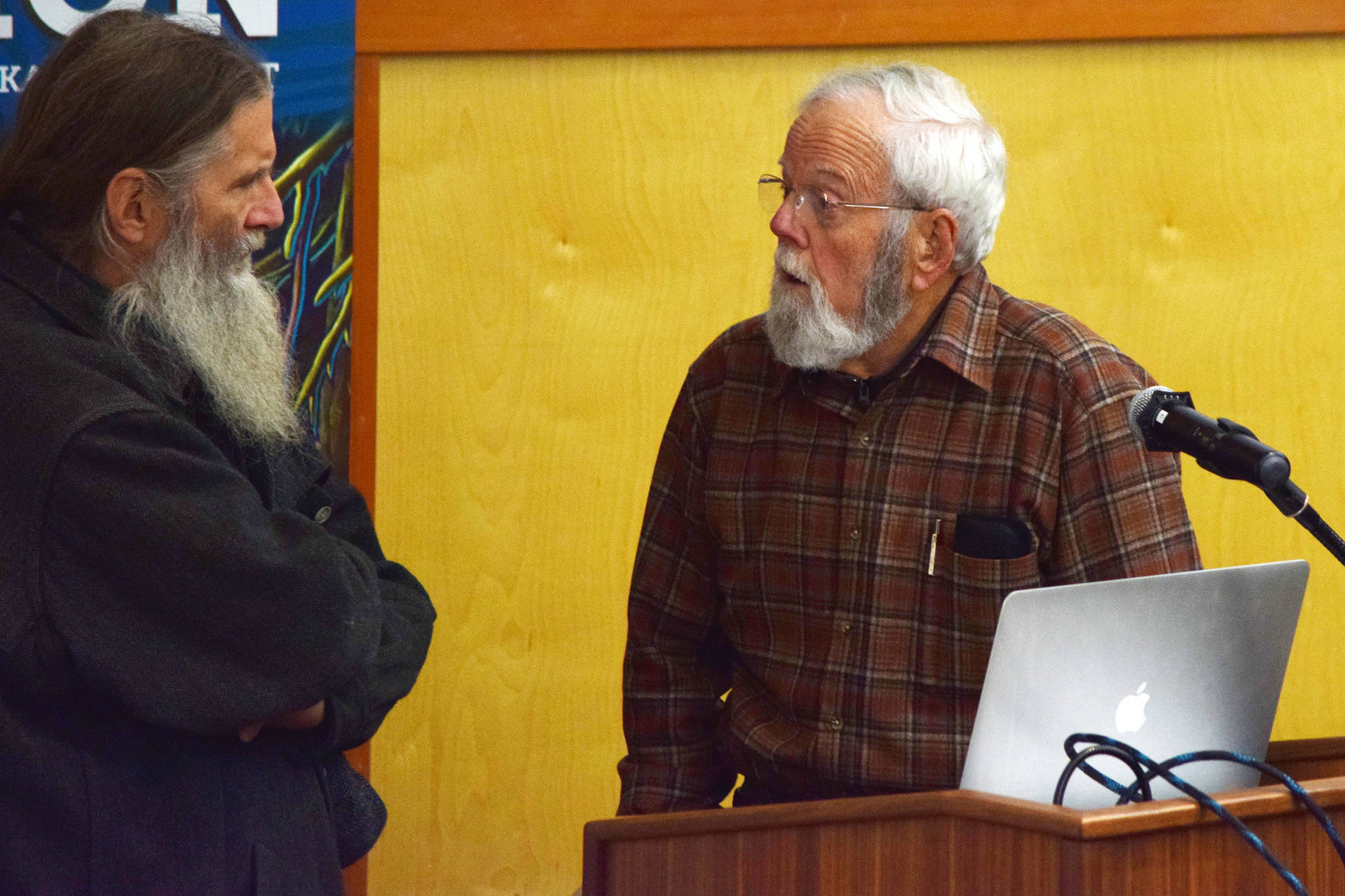 Dr. Winston Smith, research scientist at the University of Alaska Institute of Arctic Biology, speaks with a guest after his lecture on goshawk breeding season ecology at the University of Alaska Southeast on Friday, Oct. 11, 2019. (Nolin Ainsworth | Juneau Empire)